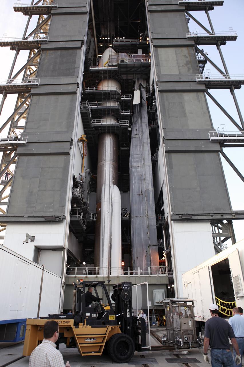 CAPE CANAVERAL, Fla. -- Backdropped by the Atlas V rocket standing inside the Vertical Integration Facility at Space Launch Complex 41, the multi-mission radioisotope thermoelectric generator (MMRTG) for NASA's Mars Science Laboratory (MSL) mission, enclosed in the mesh container known as the "gorilla cage," is removed from its trailer. The generator will be lifted up to the top of the rocket and installed on the MSL spacecraft, encapsulated within the payload fairing.    The MMRTG will generate the power needed for the mission from the natural decay of plutonium-238, a non-weapons-grade form of the radioisotope. Heat produced by this natural decay will provide constant power through the day and night during all seasons. MSL's components include a car-sized rover, Curiosity, which has 10 science instruments designed to search for signs of life, including methane, and help determine if the gas is from a biological or geological source. Heat emitted by the MMRTG will be circulated throughout the rover system to keep instruments, computers, mechanical devices and communications systems within their operating temperature ranges. Launch of MSL aboard a United Launch Alliance Atlas V rocket is targeted for Nov. 25 from Space Launch Complex 41 on Cape Canaveral Air Force Station. For more information, visit http://www.nasa.gov/msl. Photo credit: NASA/Dimitri Gerondidakis