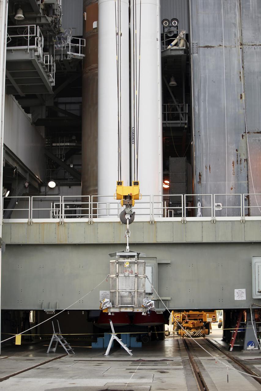 CAPE CANAVERAL, Fla. -- Enclosed in the protective mesh container known as the "gorilla cage," the multi-mission radioisotope thermoelectric generator (MMRTG) for NASA's Mars Science Laboratory (MSL) mission is lifted off the ground at the Vertical Integration Facility at Space Launch Complex 41. The generator will be hoisted up to the top of the rocket and installed on the MSL spacecraft, encapsulated within the payload fairing.    The MMRTG will generate the power needed for the mission from the natural decay of plutonium-238, a non-weapons-grade form of the radioisotope. Heat produced by this natural decay will provide constant power through the day and night during all seasons. MSL's components include a car-sized rover, Curiosity, which has 10 science instruments designed to search for signs of life, including methane, and help determine if the gas is from a biological or geological source. Heat emitted by the MMRTG will be circulated throughout the rover system to keep instruments, computers, mechanical devices and communications systems within their operating temperature ranges. Launch of MSL aboard a United Launch Alliance Atlas V rocket is targeted for Nov. 25 from Space Launch Complex 41 on Cape Canaveral Air Force Station. For more information, visit http://www.nasa.gov/msl. Photo credit: NASA/Dimitri Gerondidakis