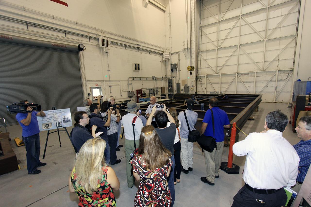 CAPE CANAVERAL, Fla. – Members of the media tour several facilities, including the Launch Equipment Test Facility in the Industrial Area, during the 21st Century Ground Systems Program Tour at Kennedy Space Center in Florida. Other tour stops were the Operations & Checkout Building, the Multi-Payload Processing Facility and the Canister Rotation Facility.      NASA’s 21st Century Ground Systems Program was initiated at Kennedy Space Center to establish the needed launch and processing infrastructure to support the Space Launch System Program and to work toward transforming the landscape of the launch site for a multi-faceted user community. Photo credit: NASA/Jim Grossmann