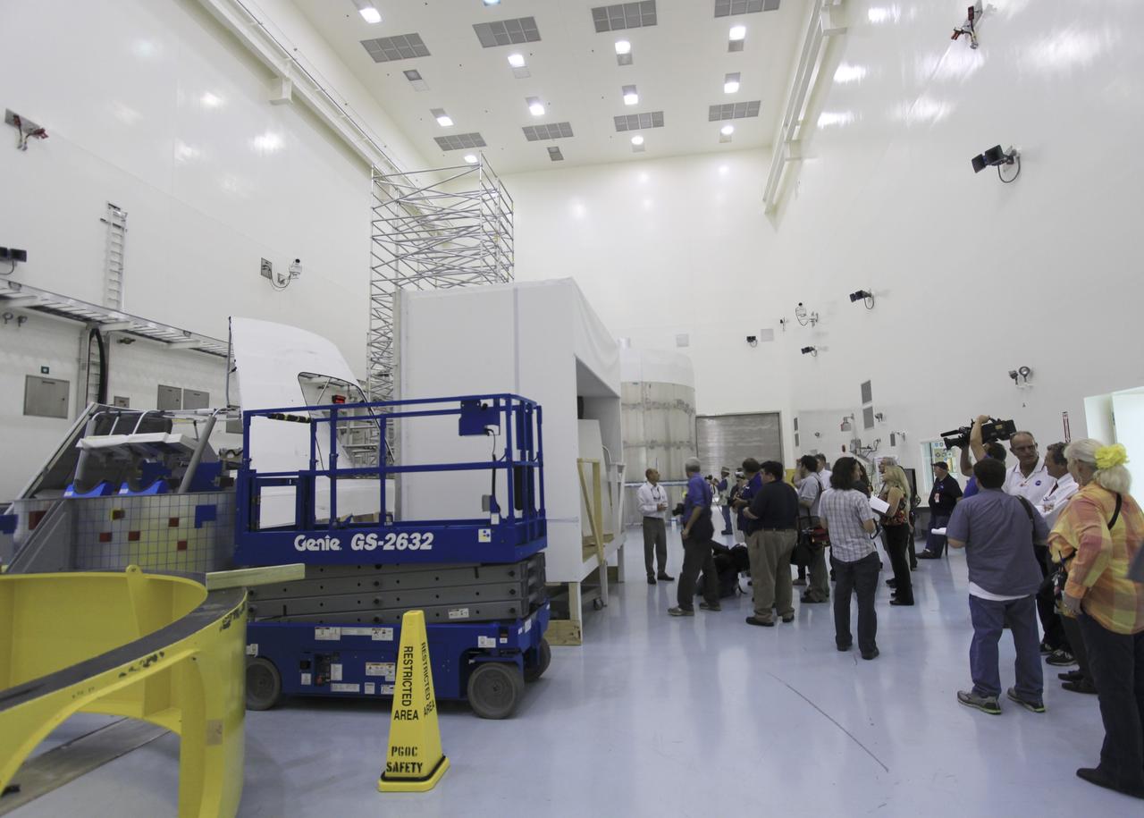 CAPE CANAVERAL, Fla. – Members of the media tour several facilities, including the Multi-Payload Processing Facility, during the 21st Century Ground Systems Program Tour at Kennedy Space Center in Florida. Other tour stops were the Launch Equipment Test Facility, the Operations & Checkout Building and the Canister Rotation Facility.    NASA’s 21st Century Ground Systems Program was initiated at Kennedy Space Center to establish the needed launch and processing infrastructure to support the Space Launch System Program and to work toward transforming the landscape of the launch site for a multi-faceted user community. Photo credit: NASA/Jim Grossmann