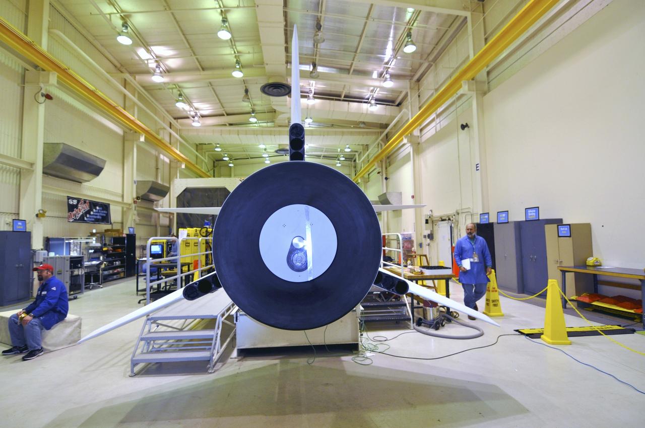 VANDENBERG AIR FORCE BASE, Calif. -- Inside a Pegasus booster processing facility at Vandenberg Air Force Base in California, all three fins on the aft end of the Pegasus XL rocket's first stage have been installed.      The Orbital Sciences Corp. Pegasus rocket will launch the Nuclear Spectroscopic Telescope Array (NuSTAR) into space. After the rocket and spacecraft are processed at Vandenberg, they will be flown on the Orbital Sciences’ L-1011 carrier aircraft to the Ronald Reagan Ballistic Missile Defense Test Site at the Pacific Ocean’s Kwajalein Atoll for launch. The high-energy x-ray telescope will conduct a census for black holes, map radioactive material in young supernovae remnants, and study the origins of cosmic rays and the extreme physics around collapsed stars. For more information, visit science.nasa.gov/missions/nustar/. Photo credit: NASA/Randy Beaudoin, VAFB