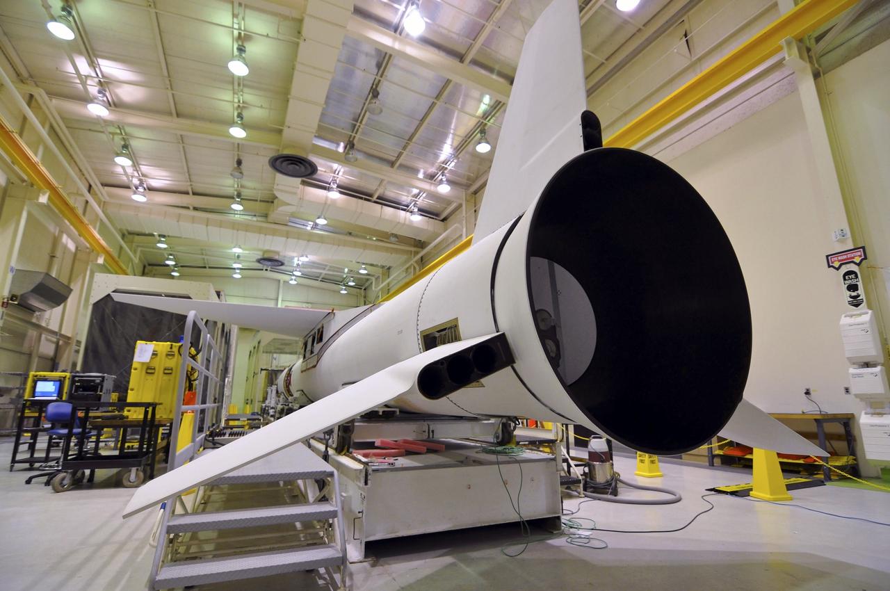 VANDENBERG AIR FORCE BASE, Calif. -- Inside a Pegasus booster processing facility at Vandenberg Air Force Base in California, all three fins on the aft end of the Pegasus XL rocket's first stage have been installed.    The Orbital Sciences Corp. Pegasus rocket will launch the Nuclear Spectroscopic Telescope Array (NuSTAR) into space. After the rocket and spacecraft are processed at Vandenberg, they will be flown on the Orbital Sciences’ L-1011 carrier aircraft to the Ronald Reagan Ballistic Missile Defense Test Site at the Pacific Ocean’s Kwajalein Atoll for launch. The high-energy x-ray telescope will conduct a census for black holes, map radioactive material in young supernovae remnants, and study the origins of cosmic rays and the extreme physics around collapsed stars. For more information, visit science.nasa.gov/missions/nustar/. Photo credit: NASA/Randy Beaudoin, VAFB