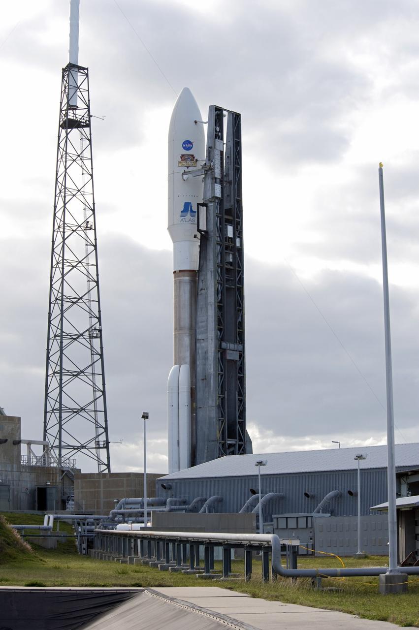 CAPE CANAVERAL, Fla. -- On Cape Canaveral Air Force Station in Florida, one of three lightning masts, at left, protects the 197-foot-tall United Launch Alliance Atlas V rocket as it rolls from the safety of the Vertical Integration Facility (VIF) at Space Launch Complex-41 to the pad's surface. Atop the rocket is NASA's Mars Science Laboratory (MSL), enclosed in its payload fairing. The rocket began its move from the VIF at 8 a.m. EST. Liftoff is planned during a launch window which extends from 10:02 a.m. to 11:45 a.m. EST on Nov. 26. MSL's components include a car-sized rover, Curiosity, which has 10 science instruments designed to search for signs of life, including methane, and help determine if the gas is from a biological or geological source. For more information, visit http://www.nasa.gov/msl. Photo credit: NASA/Tony Gray