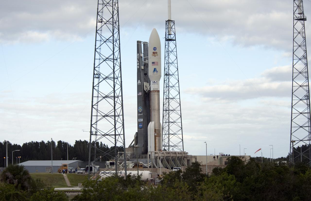 CAPE CANAVERAL, Fla. -- On Cape Canaveral Air Force Station in Florida, lightning masts protect the 197-foot-tall United Launch Alliance Atlas V rocket as it leaves behind the safety of the Vertical Integration Facility (VIF) at Space Launch Complex-41 to take its position on the pad's surface. Atop the rocket is NASA's Mars Science Laboratory (MSL), enclosed in its payload fairing. The rocket began its move from the VIF at 8 a.m. EST. Liftoff is planned during a launch window which extends from 10:02 a.m. to 11:45 a.m. EST on Nov. 26. MSL's components include a car-sized rover, Curiosity, which has 10 science instruments designed to search for signs of life, including methane, and help determine if the gas is from a biological or geological source. For more information, visit http://www.nasa.gov/msl. Photo credit: NASA/Tony Gray