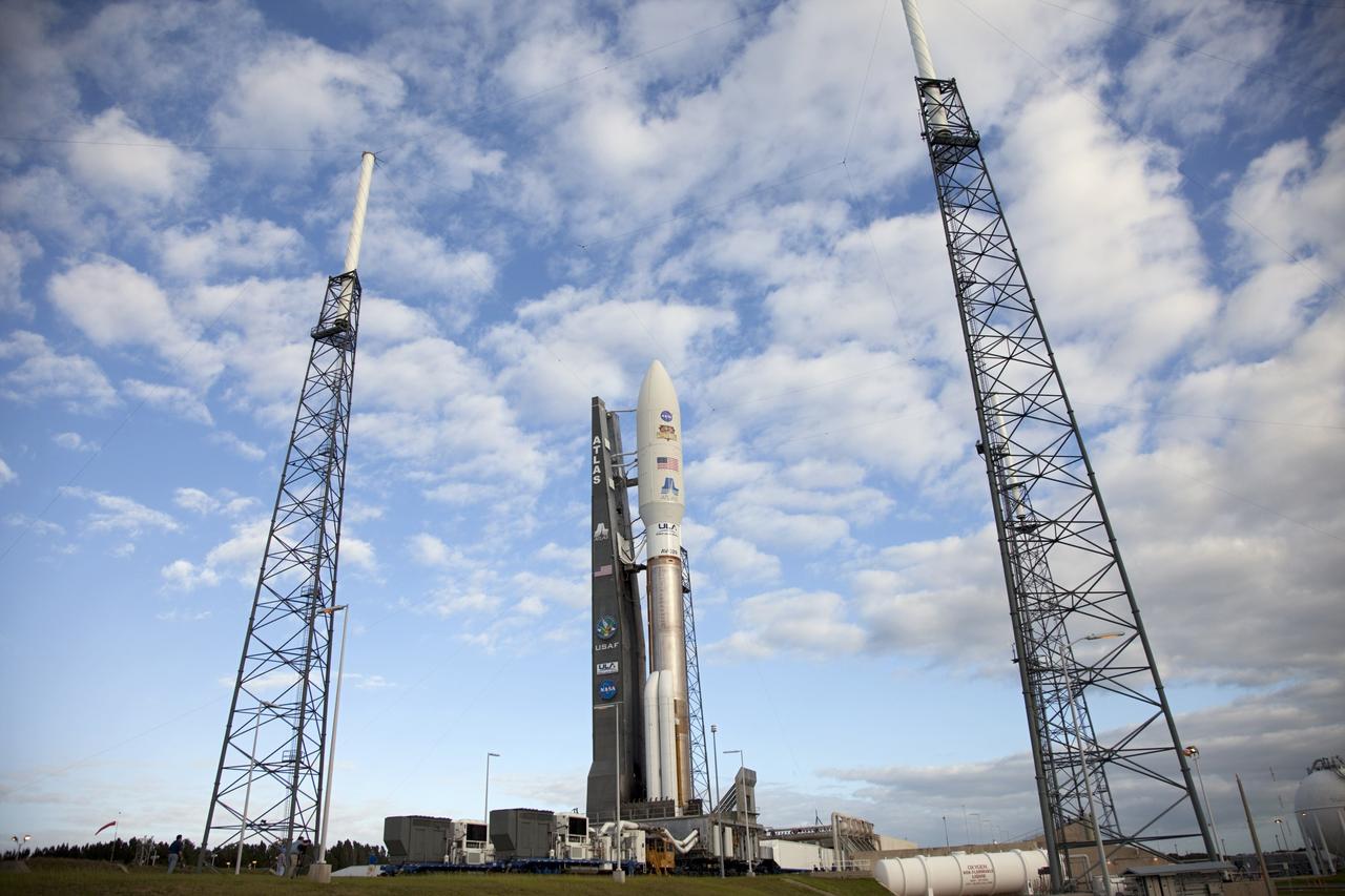 CAPE CANAVERAL, Fla. -- Surrounded by four towering lightning masts, the 197-foot-tall United Launch Alliance Atlas V rocket arrives at the launch pad at Space Launch Complex 41 on Cape Canaveral Air Force Station in Florida. Atop the rocket is NASA's Mars Science Laboratory (MSL), enclosed in its payload fairing. The rocket began its move from the Vertical Integration Facility at 8 a.m. EST and arrived at the pad at 8:40 a.m. Liftoff is planned during a launch window which extends from 10:02 a.m. to 11:45 a.m. EST on Nov. 26. MSL's components include a car-sized rover, Curiosity, which has 10 science instruments designed to search for signs of life, including methane, and help determine if the gas is from a biological or geological source. For more information, visit http://www.nasa.gov/msl. Photo credit: NASA/Frankie Martin