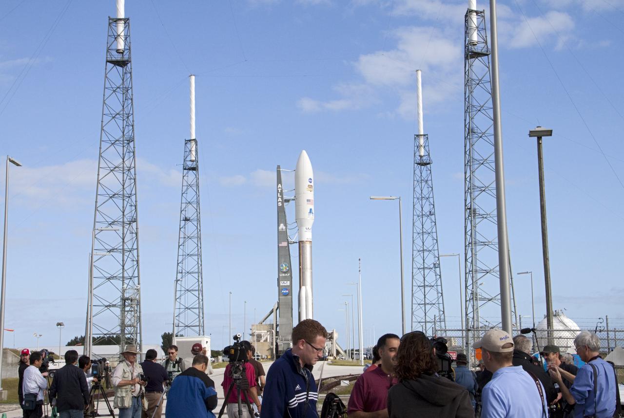 CAPE CANAVERAL, Fla. -- On Cape Canaveral Air Force Station in Florida, members of the media gather near the launch pad at Space Launch Complex 41 to document the arrival of the 197-foot-tall United Launch Alliance Atlas V rocket after an early morning move from the nearby Vertical Integration Facility (VIF). Atop the rocket is NASA's Mars Science Laboratory (MSL), enclosed in its payload fairing. The rocket began its move from the VIF at 8 a.m. EST and reached the launch pad at 8:40 a.m.    Liftoff is planned during a launch window which extends from 10:02 a.m. to 11:45 a.m. EST on Nov. 26. MSL's components include a car-sized rover, Curiosity, which has 10 science instruments designed to search for signs of life, including methane, and help determine if the gas is from a biological or geological source. For more information, visit http://www.nasa.gov/msl. Photo credit: NASA/Ken Thornsley