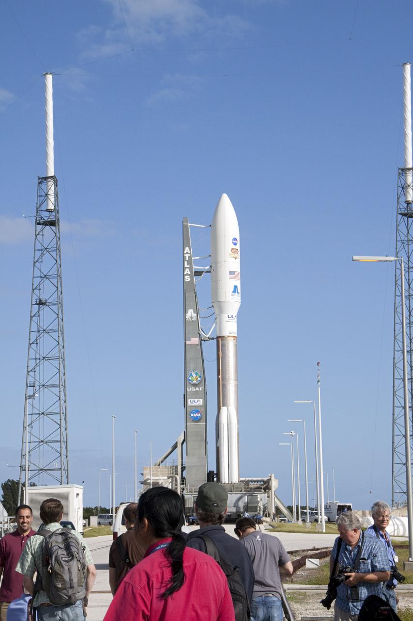 CAPE CANAVERAL, Fla. -- Members of the media gather near the launch pad at Space Launch Complex 41 on Cape Canaveral Air Force Station in Florida, documenting the arrival of the 197-foot-tall United Launch Alliance Atlas V rocket after its early morning move from the nearby Vertical Integration Facility (VIF). Atop the rocket is NASA's Mars Science Laboratory (MSL), enclosed in its payload fairing. The rocket began its move from the VIF at 8 a.m. EST and reached the launch pad at 8:40 a.m.    Liftoff is planned during a launch window which extends from 10:02 a.m. to 11:45 a.m. EST on Nov. 26. MSL's components include a car-sized rover, Curiosity, which has 10 science instruments designed to search for signs of life, including methane, and help determine if the gas is from a biological or geological source. For more information, visit http://www.nasa.gov/msl. Photo credit: NASA/Ken Thornsley