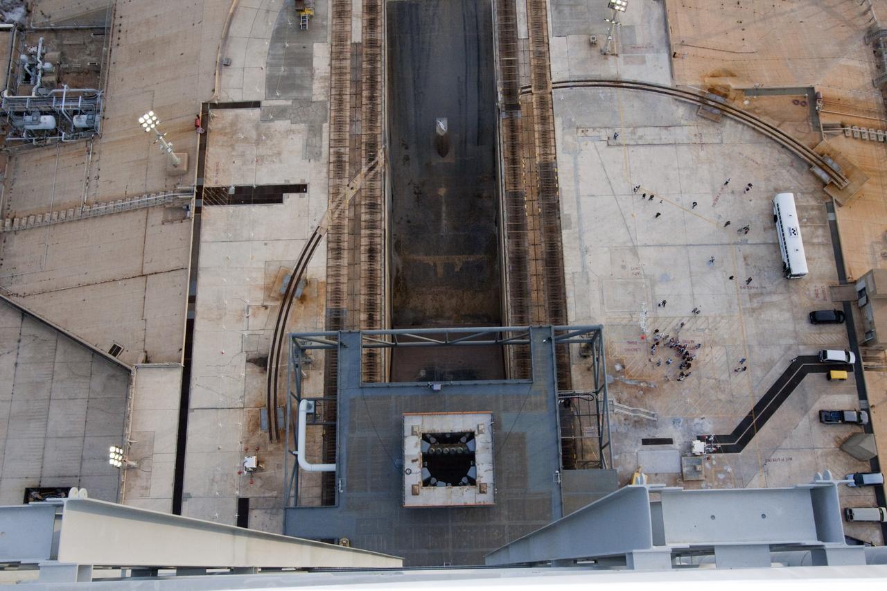 CAPE CANAVERAL, Fla. – At NASA Kennedy Space Center in Florida, media representatives taking the 21st Century Ground Systems tour appear to be the size of ants in this view from the top of the 355-foot-tall mobile launcher on Launch Pad 39B. Other stops on the tour include the Vehicle Assembly Building, a crawler-transporter parked on the crawlerway, and the Launch Control Center's Firing Room 1.  These facilities and equipment will be used to prepare and launch NASA's new Orion spacecraft on the Space Launch System heavy-lift rocket.    The tour was arranged as part of prelaunch media activities for the agency's Mars Science Laboratory (MSL) launch. Liftoff of MSL aboard a United Launch Alliance Atlas V rocket from Space Launch Complex-41 on Cape Canaveral Air Force Station is planned during a launch window which extends from 10:02 a.m. to 11:45 a.m. EST on Nov. 26. For more information, visit http://www.nasa.gov/msl. Photo credit: NASA/Jim Grossmann