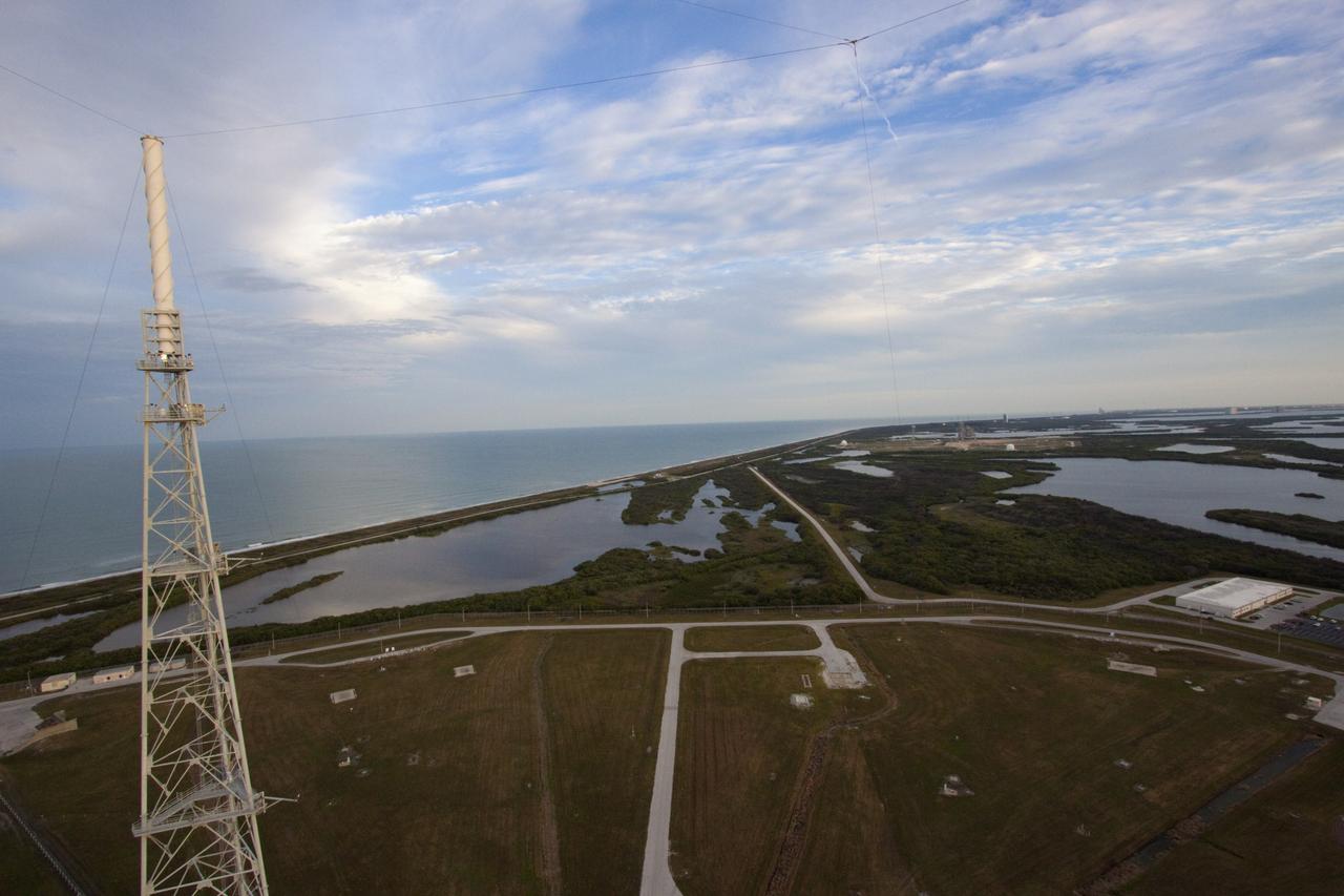 CAPE CANAVERAL, Fla. – At NASA Kennedy Space Center in Florida, this view, taken from the top of the 355-foot-tall mobile launcher at Launch Pad 39B, illustrates the close proximity of the pad to the Atlantic Ocean in the background. Media representatives are taking the 21st Century Ground Systems tour which also includes the Vehicle Assembly Building, a crawler-transporter parked on the crawlerway, and the Launch Control Center's Firing Room 1. These facilities and equipment will be used to prepare and launch NASA's new Orion spacecraft on the Space Launch System heavy-lift rocket. The tour was arranged as part of prelaunch media activities for the agency's Mars Science Laboratory (MSL) launch. Liftoff of MSL aboard a United Launch Alliance Atlas V rocket from Space Launch Complex-41 on Cape Canaveral Air Force Station is planned during a launch window which extends from 10:02 a.m. to 11:45 a.m. EST on Nov. 26. For more information, visit http://www.nasa.gov/msl. Photo credit: NASA/Jim Grossmann