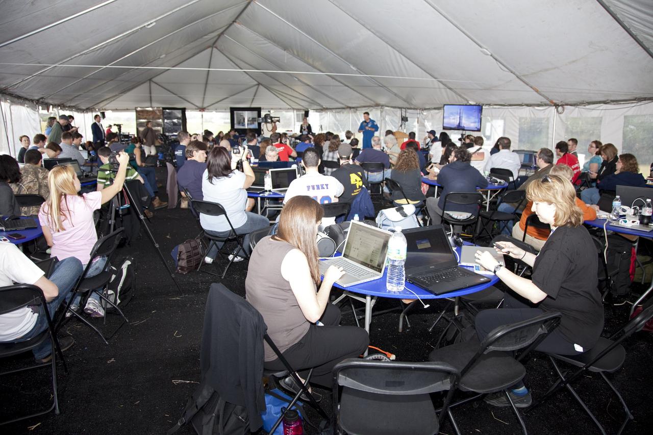 CAPE CANAVERAL, Fla. – NASA Tweetup participants hear a presentation by Expedition 25 astronaut Doug Wheelock in a tent set up at NASA Kennedy Space Center's Press Site in Florida during prelaunch activities for the agency’s Mars Science Laboratory (MSL) launch. Participants in the Tweetup are given the opportunity to listen to agency briefings, tour locations on the center normally off limits to visitors, and get a close-up view of Space Launch Complex-41 on Cape Canaveral Air Force Station. The tweeters will share their experiences with followers through the social networking site Twitter. The MSL mission will pioneer precision landing technology and a sky-crane touchdown to place a car-sized rover, Curiosity, near the foot of a mountain inside Gale Crater on Aug. 6, 2012. During a nearly two-year prime mission after landing, the rover will investigate whether the region has ever offered conditions favorable for microbial life, including the chemical ingredients for life. Liftoff of MSL aboard a United Launch Alliance Atlas V rocket from pad 41 is planned during a launch window which extends from 10:02 a.m. to 11:45 a.m. EST on Nov. 26. For more information, visit http://www.nasa.gov/msl. Photo credit: NASA/Frankie Martin