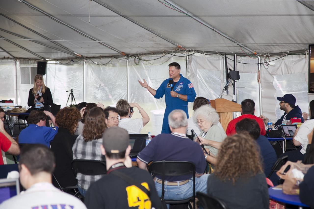 CAPE CANAVERAL, Fla. – Expedition 25 astronaut Doug Wheelock talks to the participants of a NASA Tweetup in a tent set up at NASA Kennedy Space Center's Press Site in Florida during prelaunch activities for the agency’s Mars Science Laboratory (MSL) launch. Participants in the Tweetup are given the opportunity to listen to agency briefings, tour locations on the center normally off limits to visitors, and get a close-up view of Space Launch Complex-41 on Cape Canaveral Air Force Station. The tweeters will share their experiences with followers through the social networking site Twitter. The MSL mission will pioneer precision landing technology and a sky-crane touchdown to place a car-sized rover, Curiosity, near the foot of a mountain inside Gale Crater on Aug. 6, 2012. During a nearly two-year prime mission after landing, the rover will investigate whether the region has ever offered conditions favorable for microbial life, including the chemical ingredients for life. Liftoff of MSL aboard a United Launch Alliance Atlas V rocket from pad 41 is planned during a launch window which extends from 10:02 a.m. to 11:45 a.m. EST on Nov. 26. For more information, visit http://www.nasa.gov/msl. Photo credit: NASA/Frankie Martin