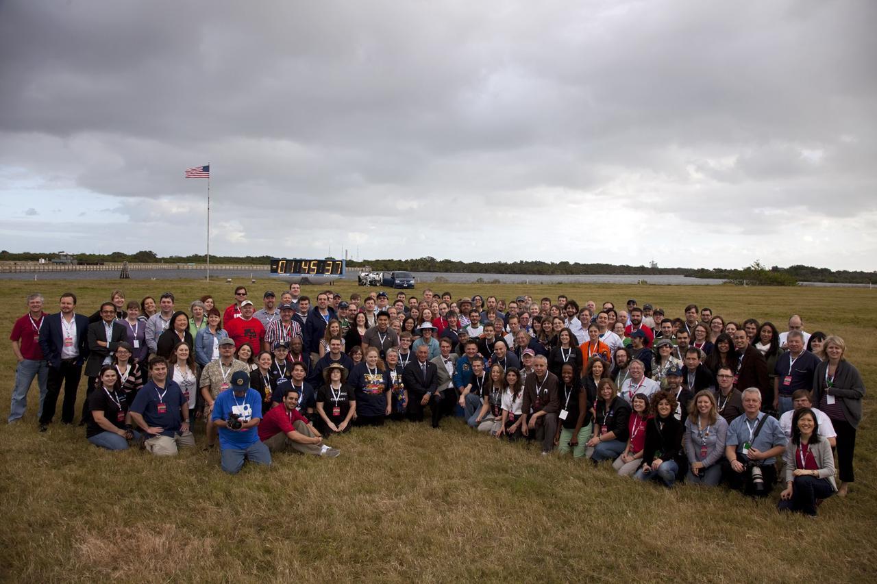 CAPE CANAVERAL, Fla. – Participants of a NASA Tweetup pose for a group portrait at NASA Kennedy Space Center's Press Site in Florida during prelaunch activities for the agency’s Mars Science Laboratory (MSL) launch. Behind them, the countdown clock ticks off the seconds to launch. Participants in the Tweetup are given the opportunity to listen to agency briefings, tour locations on the center normally off limits to visitors, and get a close-up view of Space Launch Complex-41 on Cape Canaveral Air Force Station. The tweeters will share their experiences with followers through the social networking site Twitter. The MSL mission will pioneer precision landing technology and a sky-crane touchdown to place a car-sized rover, Curiosity, near the foot of a mountain inside Gale Crater on Aug. 6, 2012. During a nearly two-year prime mission after landing, the rover will investigate whether the region has ever offered conditions favorable for microbial life, including the chemical ingredients for life. Liftoff of MSL aboard a United Launch Alliance Atlas V rocket from pad 41 is planned during a launch window which extends from 10:02 a.m. to 11:45 a.m. EST on Nov. 26. For more information, visit http://www.nasa.gov/msl. Photo credit: NASA/Frankie Martin