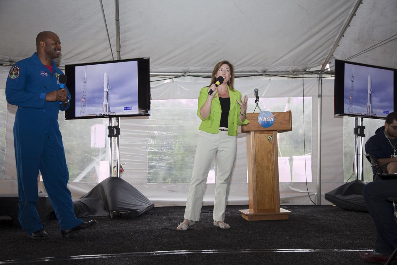 CAPE CANAVERAL, Fla. – NASA Deputy Administrator Lori Garver addresses the participants of a NASA Tweetup in a tent set up at NASA Kennedy Space Center's Press Site in Florida during prelaunch activities for the agency’s Mars Science Laboratory (MSL) launch.  Former astronaut Leland Melvin, NASA associate administrator for Education, looks on at left.  Participants in the Tweetup are given the opportunity to listen to agency briefings, tour locations on the center normally off limits to visitors, and get a close-up view of Space Launch Complex-41 on Cape Canaveral Air Force Station. The tweeters will share their experiences with followers through the social networking site Twitter. The MSL mission will pioneer precision landing technology and a sky-crane touchdown to place a car-sized rover, Curiosity, near the foot of a mountain inside Gale Crater on Aug. 6, 2012. During a nearly two-year prime mission after landing, the rover will investigate whether the region has ever offered conditions favorable for microbial life, including the chemical ingredients for life.  Liftoff of MSL aboard a United Launch Alliance Atlas V rocket from pad 41 is planned during a launch window which extends from 10:02 a.m. to 11:45 a.m. EST on Nov. 26. For more information, visit http://www.nasa.gov/msl. Photo credit: NASA/Frankie Martin