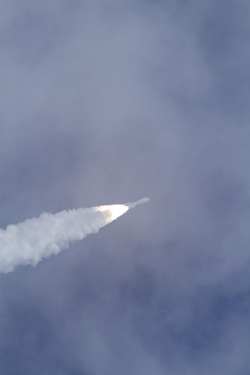 CAPE CANAVERAL, Fla. -- With NASA's Mars Science Laboratory (MSL) spacecraft sealed inside its payload fairing, the United Launch Alliance Atlas V rocket rides a plume of flames as it continues its assent into the blue sky over Space Launch Complex-41 on Cape Canaveral Air Force Station in Florida at 10:02 a.m. EST Nov. 26. MSL's components include a car-sized rover, Curiosity, which has 10 science instruments designed to search for signs of life, including methane, and help determine if the gas is from a biological or geological source. For more information, visit http://www.nasa.gov/msl. Photo credit: NASA/George Roberts