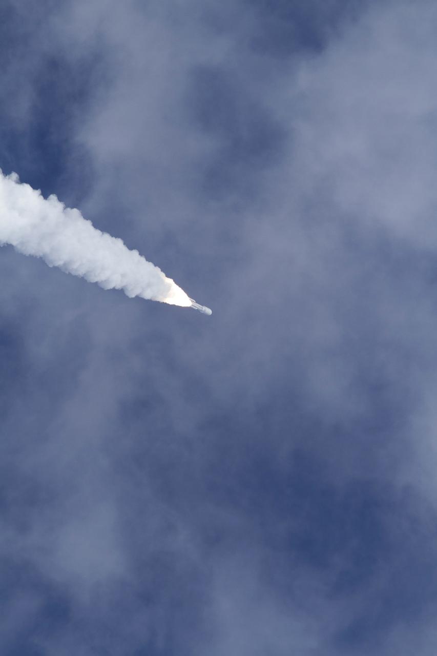 CAPE CANAVERAL, Fla. -- With NASA's Mars Science Laboratory (MSL) spacecraft sealed inside its payload fairing, the United Launch Alliance Atlas V rocket rides a plume of flames as it continues its assent into the blue sky over Space Launch Complex-41 on Cape Canaveral Air Force Station in Florida at 10:02 a.m. EST Nov. 26. MSL's components include a car-sized rover, Curiosity, which has 10 science instruments designed to search for signs of life, including methane, and help determine if the gas is from a biological or geological source. For more information, visit http://www.nasa.gov/msl. Photo credit: NASA/George Roberts