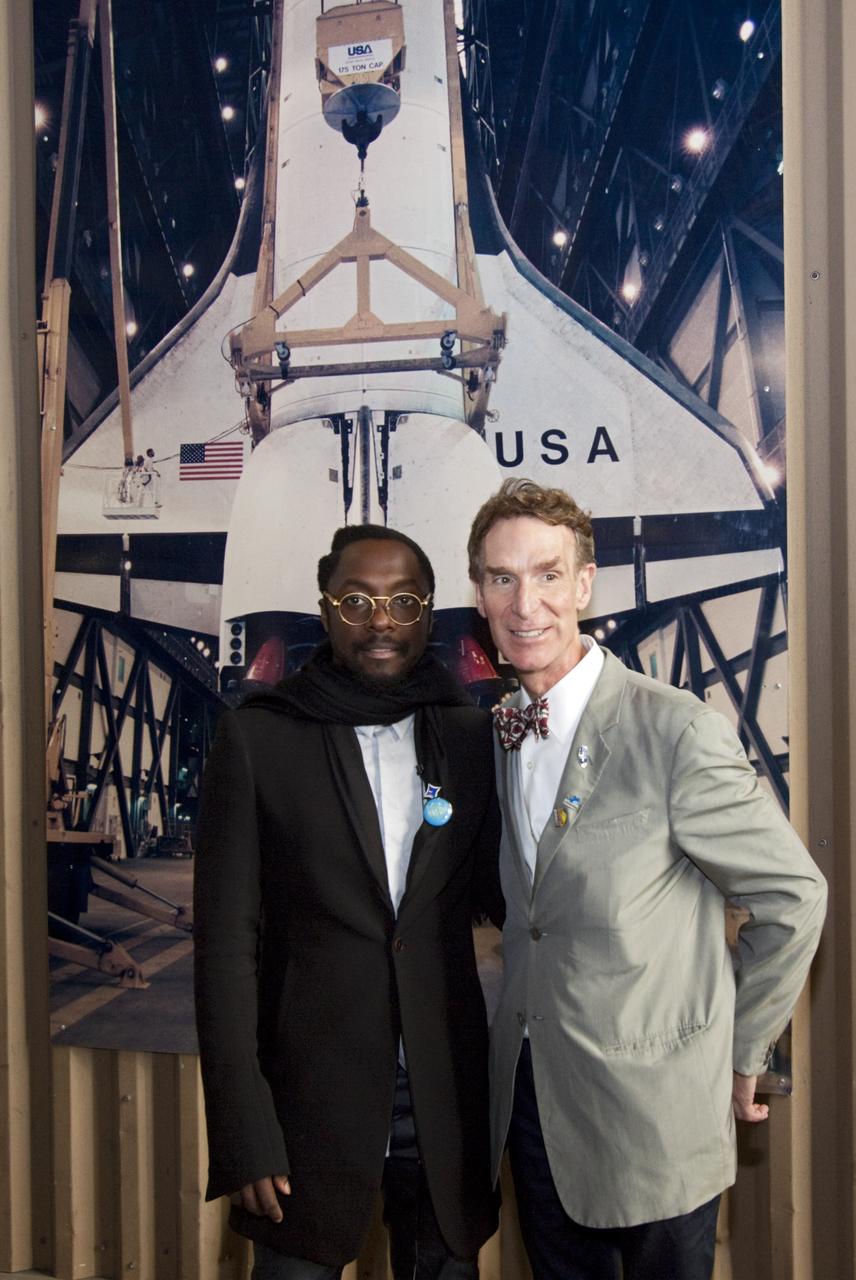 CAPE CANAVERAL, Fla. – In the Vehicle Assembly Building at NASA Kennedy Space Center in Florida, Will.i.am, entertainer and member of The Black Eyed Peas, and television personality Bill Nye the Science Guy pose in front of a picture of a space shuttle being lifted into a high bay following their participation in a NASA Tweetup.    The Tweetup is part of prelaunch activities for the agency’s Mars Science Laboratory (MSL) launch and provides the opportunity for tweeters will share their experiences with followers through the social networking site Twitter. The MSL mission will pioneer precision landing technology and a sky-crane touchdown to place a car-sized rover, Curiosity, near the foot of a mountain inside Gale Crater on Aug. 6, 2012. During a nearly two-year prime mission after landing, the rover will investigate whether the region has ever offered conditions favorable for microbial life, including the chemical ingredients for life.  Liftoff of MSL aboard a United Launch Alliance Atlas V rocket from Space Launch Complex-41 on Cape Canaveral Air Force Station was at 10:02 a.m. EST on Nov. 26. For more information, visit http://www.nasa.gov/msl. Photo credit: NASA/Jim Grossmann