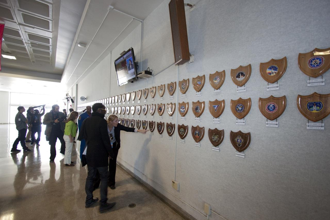 CAPE CANAVERAL, Fla. – At NASA Kennedy Space Center in Florida, Will.i.am, entertainer and member of The Black Eyed Peas, hears about the space shuttle mission plaques lining the lobby of the Launch Control Center (LCC) from NASA's Charlie Blackwell Thompson. Also viewing the plaques in the background are NASA Deputy Administrator Lori Garver and former astronaut Leland Melvin, NASA associate administrator for Education. The visit to the LCC followed their participation in a NASA Tweetup.      The Tweetup is part of prelaunch activities for the agency’s Mars Science Laboratory (MSL) launch and provides the opportunity for tweeters will share their experiences with followers through the social networking site Twitter. The MSL mission will pioneer precision landing technology and a sky-crane touchdown to place a car-sized rover, Curiosity, near the foot of a mountain inside Gale Crater on Aug. 6, 2012. During a nearly two-year prime mission after landing, the rover will investigate whether the region has ever offered conditions favorable for microbial life, including the chemical ingredients for life.  Liftoff of MSL aboard a United Launch Alliance Atlas V rocket from Space Launch Complex-41 on Cape Canaveral Air Force Station was at 10:02 a.m. EST on Nov. 26. For more information, visit http://www.nasa.gov/msl. Photo credit: NASA/Jim Grossmann
