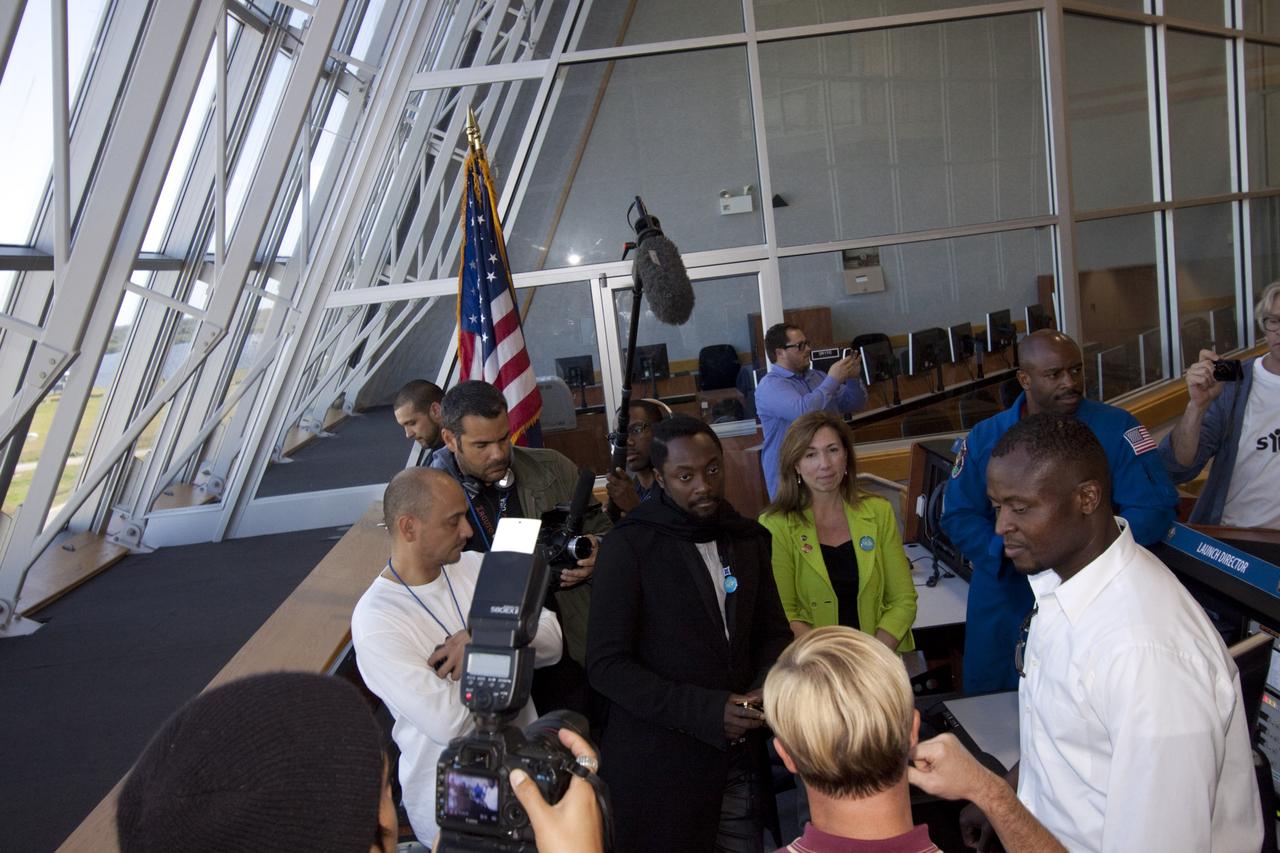 CAPE CANAVERAL, Fla. – At NASA Kennedy Space Center in Florida, Will.i.am (at center), entertainer and member of The Black Eyed Peas, tours Firing Room 4 in the Launch Control Center accompanied by NASA Deputy Administrator Lori Garver (green jacket); former astronaut Leland Melvin, NASA associate administrator for Education (blue flight suit); and Yves Lamothe, lead systems engineer for the 21st Century Ground Systems Program at Kennedy.  The visit to the firing room followed their participation in a NASA Tweetup.    The Tweetup is part of prelaunch activities for the agency’s Mars Science Laboratory (MSL) launch and provides the opportunity for tweeters will share their experiences with followers through the social networking site Twitter. The MSL mission will pioneer precision landing technology and a sky-crane touchdown to place a car-sized rover, Curiosity, near the foot of a mountain inside Gale Crater on Aug. 6, 2012. During a nearly two-year prime mission after landing, the rover will investigate whether the region has ever offered conditions favorable for microbial life, including the chemical ingredients for life.  Liftoff of MSL aboard a United Launch Alliance Atlas V rocket from Space Launch Complex-41 on Cape Canaveral Air Force Station was at 10:02 a.m. EST on Nov. 26. For more information, visit http://www.nasa.gov/msl. Photo credit: NASA/Jim Grossmann