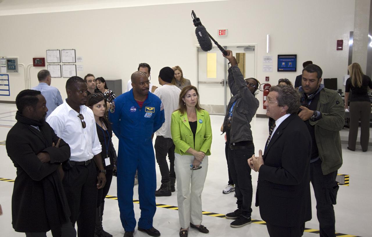 CAPE CANAVERAL, Fla. – At NASA Kennedy Space Center in Florida, Will.i.am (left), entertainer and member of The Black Eyed Peas, accompanied by Yves Lamothe, lead systems engineer for the 21st Century Ground Systems Program at Kennedy; former astronaut Leland Melvin, NASA associate administrator for Education (blue flight suit), and NASA Deputy Administrator Lori Garver (green jacket), receives a tour of the Operations and Checkout Building (O&C) from Larry Price, Lockheed Martin deputy program manager. The visit to the O&C followed their participation in a NASA Tweetup. The Tweetup is part of prelaunch activities for the agency’s Mars Science Laboratory (MSL) launch and provides the opportunity for tweeters will share their experiences with followers through the social networking site Twitter. The MSL mission will pioneer precision landing technology and a sky-crane touchdown to place a car-sized rover, Curiosity, near the foot of a mountain inside Gale Crater on Aug. 6, 2012. During a nearly two-year prime mission after landing, the rover will investigate whether the region has ever offered conditions favorable for microbial life, including the chemical ingredients for life. Liftoff of MSL aboard a United Launch Alliance Atlas V rocket from Space Launch Complex-41 on Cape Canaveral Air Force Station was at 10:02 a.m. EST on Nov. 26. For more information, visit http://www.nasa.gov/msl. Photo credit: NASA/Jim Grossmann