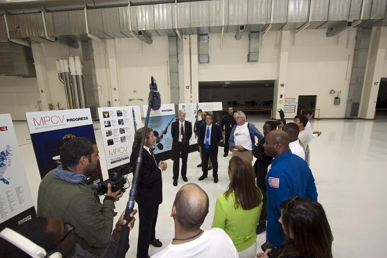 CAPE CANAVERAL, Fla. – At NASA Kennedy Space Center in Florida, presenters in a NASA Tweetup tour the Operations and Checkout Building (O&C). Listening to a briefing from from Larry Price, Lockheed Martin deputy program manager, on the Orion Multi Purpose Crew Vehicle are, from left, NASA Deputy Administrator Lori Garver (green jacket); former astronaut Leland Melvin, NASA associate administrator for Education (blue flight suit); Yves Lamothe, lead systems engineer for the 21st Century Ground Systems Program at Kennedy; Will.i.am, entertainer and member of The Black Eyed Peas; and Lars Perkins, chair of the Education and Public Outreach Committee of the NASA Advisory Council. The visit to the O&C followed their participation in a NASA Tweetup. The Tweetup is part of prelaunch activities for the agency’s Mars Science Laboratory (MSL) launch and provides the opportunity for tweeters will share their experiences with followers through the social networking site Twitter. The MSL mission will pioneer precision landing technology and a sky-crane touchdown to place a car-sized rover, Curiosity, near the foot of a mountain inside Gale Crater on Aug. 6, 2012. During a nearly two-year prime mission after landing, the rover will investigate whether the region has ever offered conditions favorable for microbial life, including the chemical ingredients for life. Liftoff of MSL aboard a United Launch Alliance Atlas V rocket from Space Launch Complex-41 on Cape Canaveral Air Force Station was at 10:02 a.m. EST on Nov. 26. For more information, visit http://www.nasa.gov/msl. Photo credit: NASA/Jim Grossmann
