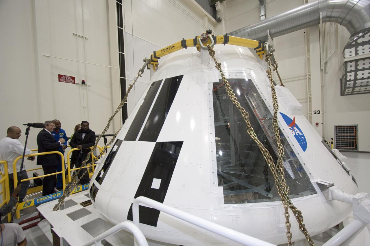 CAPE CANAVERAL, Fla. – At NASA Kennedy Space Center in Florida, Will.i.am, entertainer and member of The Black Eyed Peas, gets a close-up look at the agency's Orion Multi Purpose Crew Vehicle during a tour of the Operations and Checkout Building (O&C). Beside him is Larry Price, Lockheed Martin deputy program manager, the tour escort.  Behind him are former astronaut Leland Melvin, NASA associate administrator for Education (blue flight suit), and NASA Deputy Administrator Lori Garver (green jacket). The visit to the O&C followed their participation in a NASA Tweetup.    The Tweetup is part of prelaunch activities for the agency’s Mars Science Laboratory (MSL) launch and provides the opportunity for tweeters will share their experiences with followers through the social networking site Twitter. The MSL mission will pioneer precision landing technology and a sky-crane touchdown to place a car-sized rover, Curiosity, near the foot of a mountain inside Gale Crater on Aug. 6, 2012. During a nearly two-year prime mission after landing, the rover will investigate whether the region has ever offered conditions favorable for microbial life, including the chemical ingredients for life.  Liftoff of MSL aboard a United Launch Alliance Atlas V rocket from Space Launch Complex-41 on Cape Canaveral Air Force Station was at 10:02 a.m. EST on Nov. 26. For more information, visit http://www.nasa.gov/msl. Photo credit: NASA/Jim Grossmann