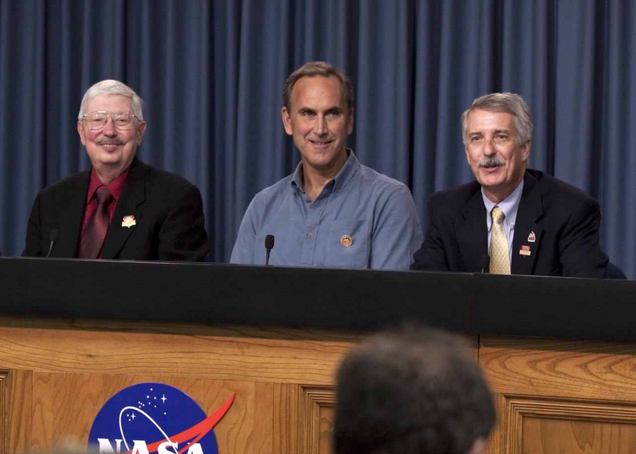 CAPE CANAVERAL, Fla. -- A trio of panelists awaits the start of a post-launch news conference at NASA's Kennedy Space Center in Florida following the successful launch of NASA's Mars Science Laboratory (MSL) mission. From left are Pete Theisinger, MSL project manager at the Jet Propulsion Laboratory in Pasadena, Calif.; John Grotzinger, MSL project scientist at the California Institute of Technology, also in Pasadena; and Doug McCuisition, director of the Mars Exploration Program at NASA Headquarters.    MSL lifted off aboard a United Launch Alliance Atlas V rocket from Space Launch Complex-41 on Cape Canaveral Air Force Station in Florida at 10:02 a.m. EST Nov. 26. MSL's components include a car-sized rover, Curiosity, which has 10 science instruments designed to search for signs of life, including methane, and help determine if the gas is from a biological or geological source. For more information, visit http://www.nasa.gov/msl. Photo credit: NASA/Kim Shiflett