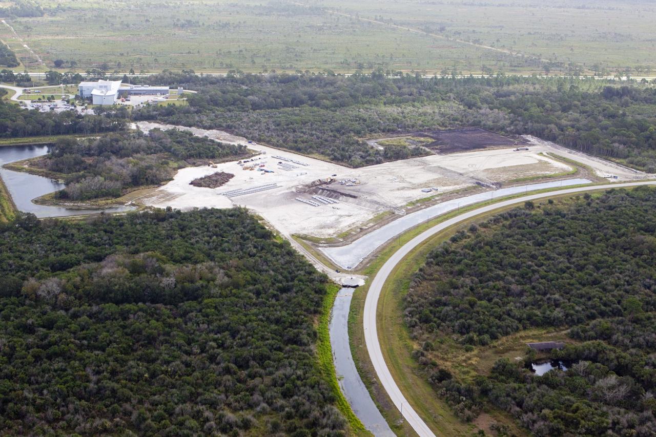 CAPE CANAVERAL, Fla. - The Exploration Park site near the Space Life Sciences Laboratory (SLSL) at NASA's Kennedy Space Center in Florida. The first phase will encompass 60 acres just outside Kennedy’s security gates. Nine buildings will provide 350,000-square feet of work space, including educational, office, research and lab, and high-bay facilities. Each building is expected to be certified in the U.S. Green Building Council’s Leadership in Environmental and Energy Design (LEED). Exploration Park is designed to be a strategically located complex, adjacent to the SLSL, for servicing diverse tenants and uses that will engage in activities to support space-related activities of NASA, other government agencies and the U.S. commercial space industry. The SLSL will be the anchor facility for the park. Photo credit: NASA/Kim Shiflett