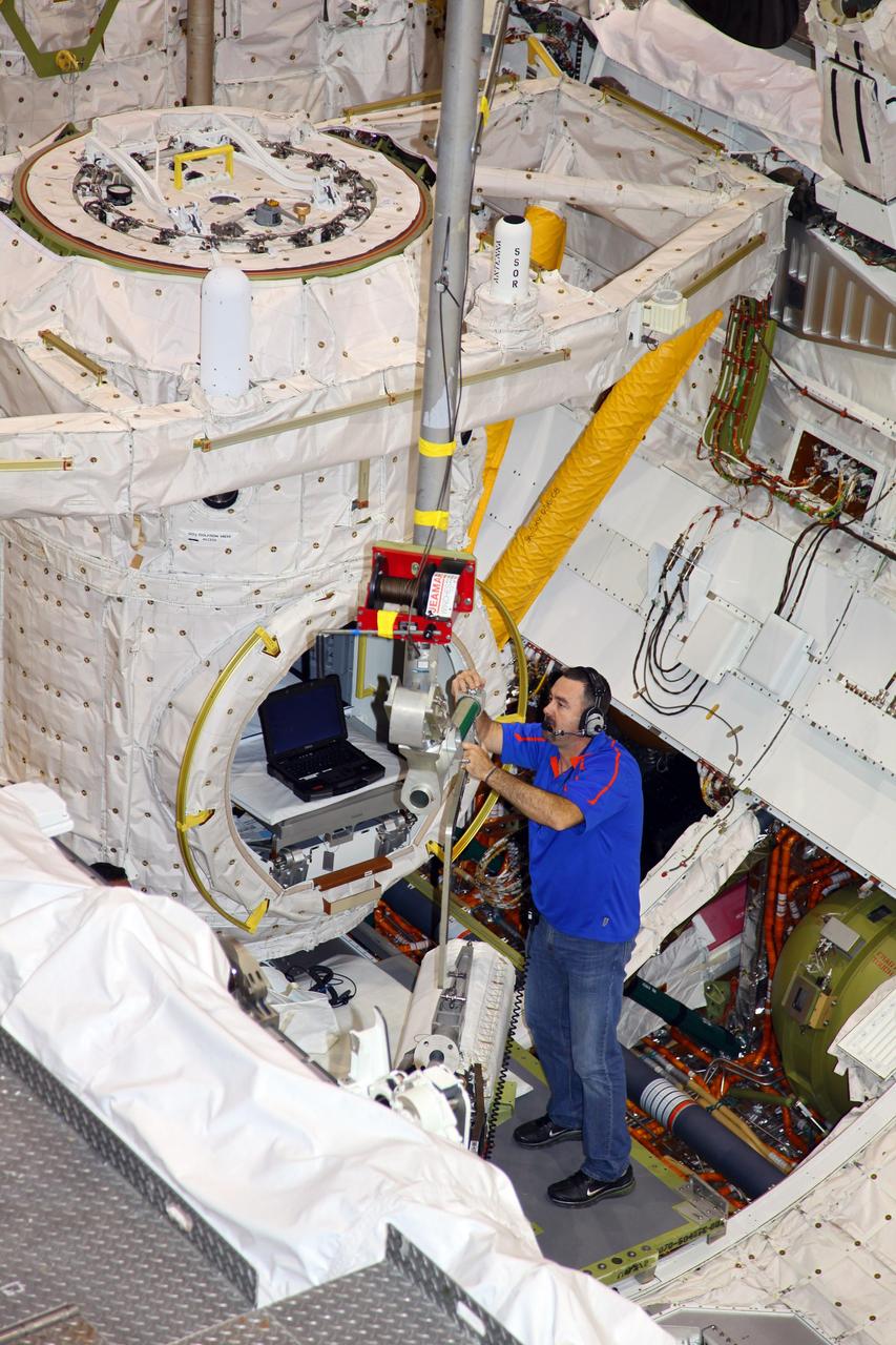 CAPE CANAVERAL, Fla. -- Inside Orbiter Processing Facility-1 at NASA’s Kennedy Space Center in Florida, technicians prepare space shuttle Discovery’s three fuel cells to be drained of all fluids.    After all of the coolant is removed, the fuel cells will be returned to their previous location within Discovery’s mid-body. The hydrogen and oxygen dewars which feed reactants to the fuel cells remain in Discovery’s mid-body and have been purged with inert gases and vented down. The work is part of the Space Shuttle Program’s transition and retirement processing of shuttle Discovery. Discovery is being prepared for display at the Smithsonian’s National Air and Space Museum, Steven F. Udvar-Hazy Center in Chantilly, Va. For more information, visit http://www.nasa.gov/shuttle.  Photo credit: NASA/Frankie Martin