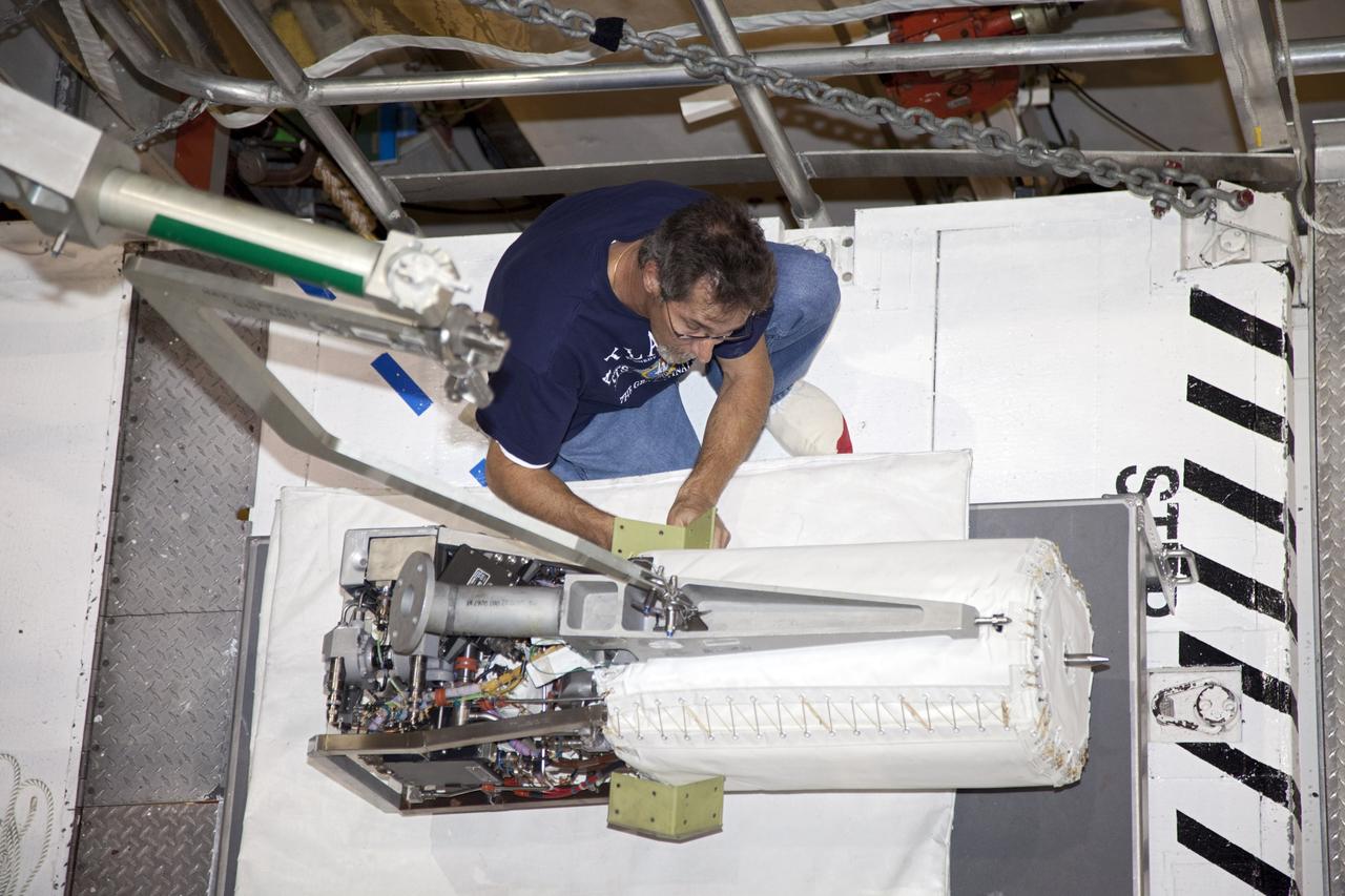 CAPE CANAVERAL, Fla. -- Inside Orbiter Processing Facility-1 at NASA’s Kennedy Space Center in Florida, a technician prepares one of space shuttle Discovery’s three fuel cells to be drained of all fluids.    After all of the coolant is removed, the fuel cells will be returned to their previous location within Discovery’s mid-body. The hydrogen and oxygen dewars which feed reactants to the fuel cells remain in Discovery’s mid-body and have been purged with inert gases and vented down. The work is part of the Space Shuttle Program’s transition and retirement processing of shuttle Discovery. Discovery is being prepared for display at the Smithsonian’s National Air and Space Museum, Steven F. Udvar-Hazy Center in Chantilly, Va. For more information, visit http://www.nasa.gov/shuttle.  Photo credit: NASA/Frankie Martin
