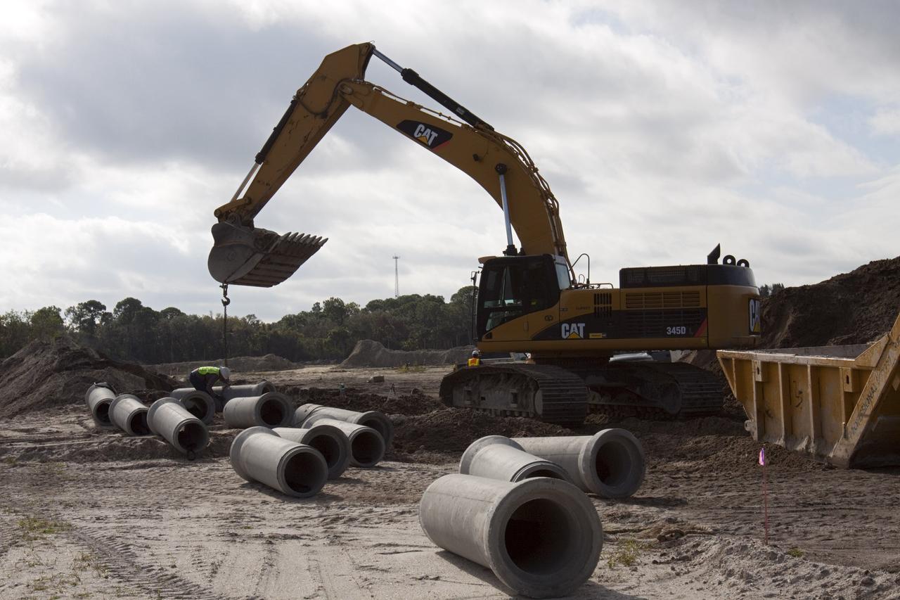 CAPE CANAVERAL, Fla. – Construction work progresses on Phase I of Exploration Park at NASA’s Kennedy Space Center in Florida.    Exploration Park is near the Space Life Sciences Laboratory (SLSL). The first phase encompasses 60 acres just outside Kennedy’s security gates. Nine buildings will provide 350,000-square feet of work space, including educational, office, research and lab, and high-bay facilities. Each building is expected to be certified in the U.S. Green Building Council’s Leadership in Environmental and Energy Design (LEED). Exploration Park is designed to be a strategically located complex, adjacent to the SLSL, for servicing diverse tenants and uses that will engage in activities to support space-related activities of NASA, other government agencies and the U.S. commercial space industry. The SLSL will be the anchor facility for the park. Photo credit: NASA/Kim Shiflett