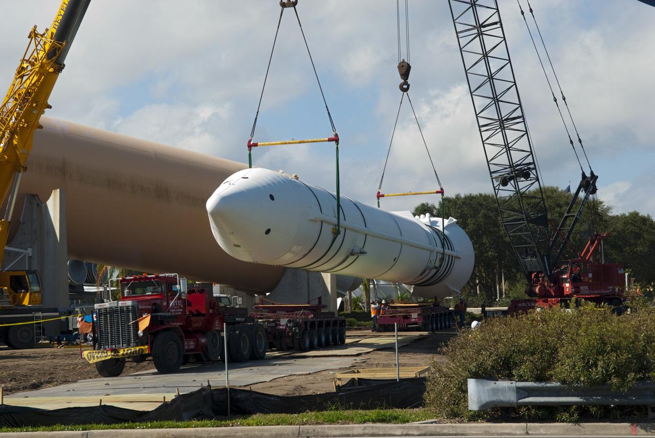 CAPE CANAVERAL, Fla. – Cranes remove a full-size, 149-foot-long, space shuttle solid rocket booster, or SRB, replica from the Kennedy Space Center Visitor Complex as the space-themed attraction makes way for a new exhibit featuring space shuttle Atlantis, which is currently undergoing preparations to go on public display. The SRB is being placed into temporary storage at NASA's Kennedy Space Center. The SRB was part of a mockup of the external tank and two SRBs at the visitor complex that were used to show visitors the size of actual space shuttle components. A space shuttle rode piggyback on the tank and boosters at liftoff and during the ascent into space. The SRBs burned out after about two-and-a-half minutes of flight. After recovery from the ocean, the boosters could be used repeatedly. Photo credit: NASA/Jim Grossmann