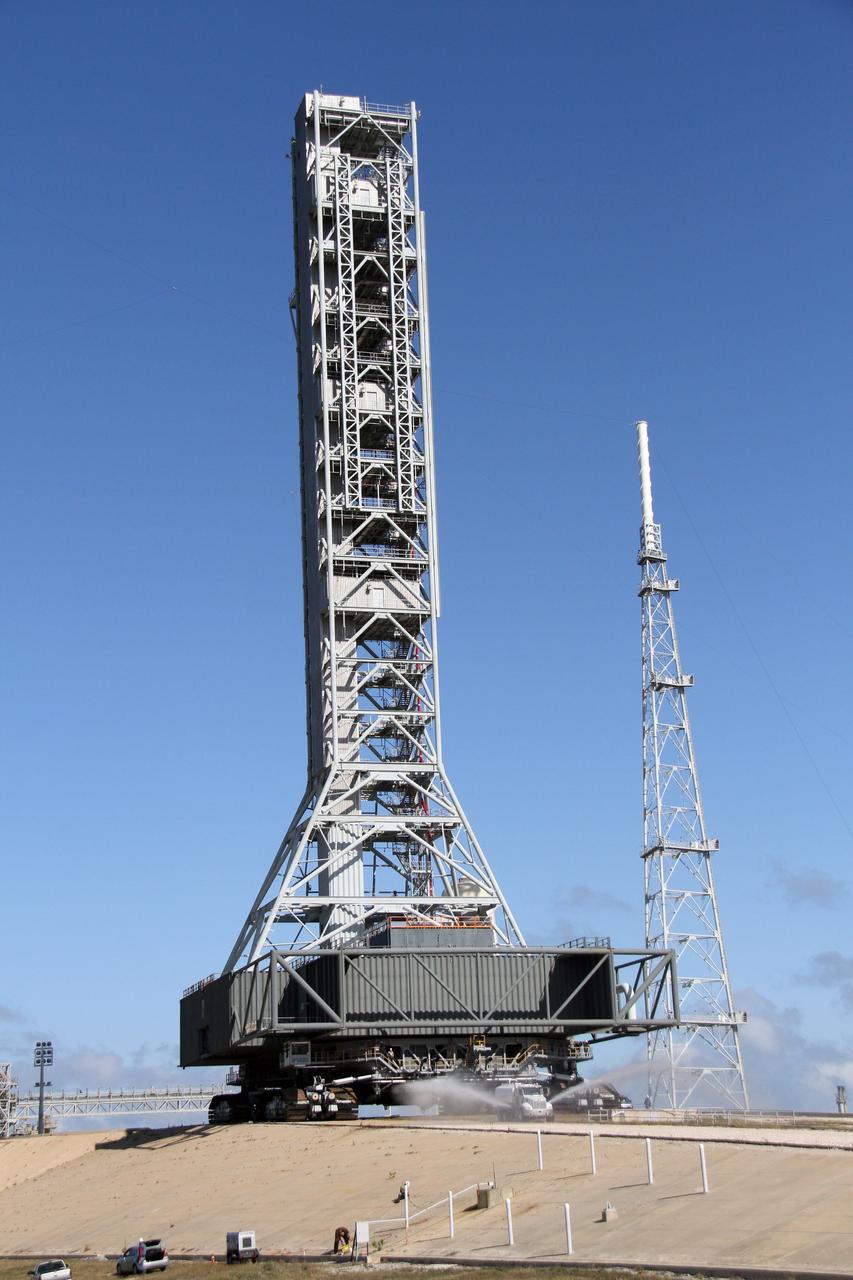 CAPE CANAVERAL, Fla. – The crawlerway at Launch Pad 39B at NASA's Kennedy Space Center in Florida is sprayed with water to reduce the dust that will fly as the crawler-transporter rolls along. The crawler is returning the mobile launcher, or ML, back to the park site near the Vehicle Assembly Building.     Data on the ML collected from structural and functional engineering tests during its two-week stay on the pad will be used in the next phases of construction. The 355-foot-tall ML structure, which took about two years to construct, will be modified by NASA’s 21st Century Ground Systems Program to support NASA’s Space Launch System, the heavy-lift rocket that will launch astronauts into deep space on future exploration missions. For more information, visit http://www.nasa.gov/exploration/systems/sls. Photo credit: NASA/Cory Huston