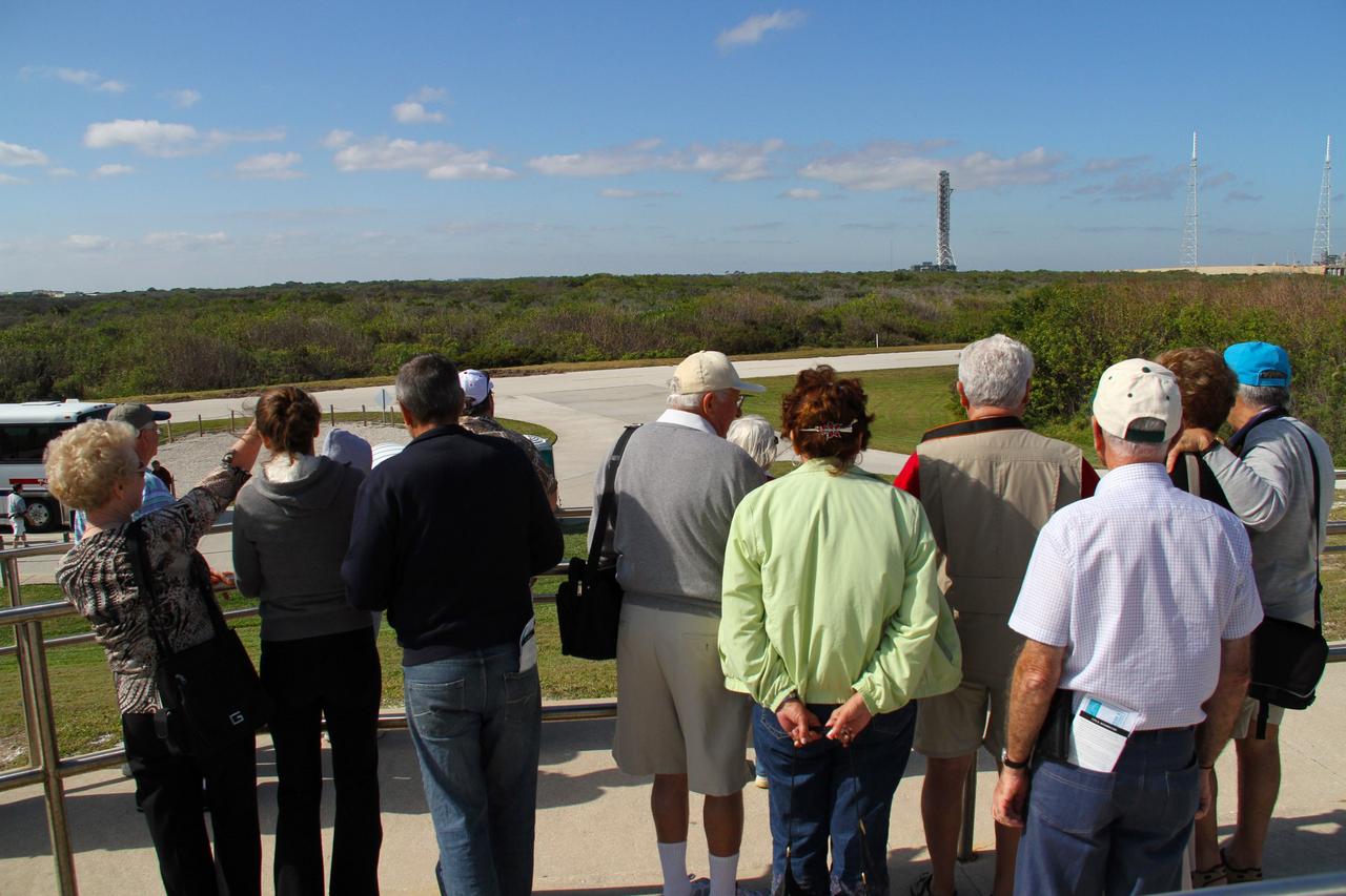 CAPE CANAVERAL, Fla. – Visitors on the Launch Complex 39 Observation Gantry at NASA's Kennedy Space Center in Florida experience a rare site -- the mobile launcher, or ML, rolling along the crawlerway from Launch Pad 39B to the park site near the Vehicle Assembly Building.     Data on the ML collected from structural and functional engineering tests during its two-week stay on the pad will be used in the next phases of construction. The 355-foot-tall ML structure, which took about two years to construct, will be modified by NASA’s 21st Century Ground Systems Program to support NASA’s Space Launch System, the heavy-lift rocket that will launch astronauts into deep space on future exploration missions. For more information, visit http://www.nasa.gov/exploration/systems/sls. Photo credit: NASA/Cory Huston