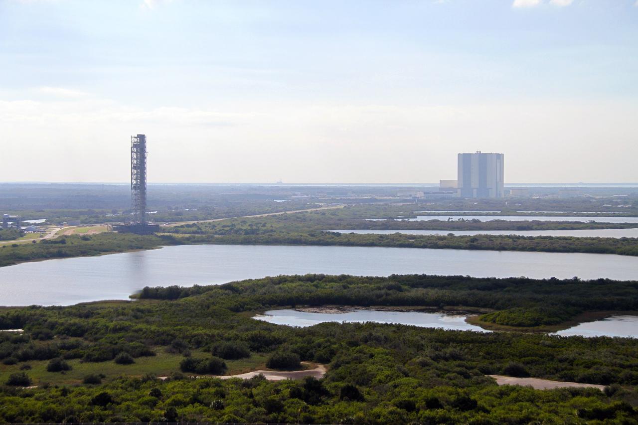 CAPE CANAVERAL, Fla. – The mobile launcher, or ML, negotiates the 4.2-mile stretch of crawlerway between Launch Pad 39B and the Vehicle Assembly Building at NASA's Kennedy Space Center in Florida.    Data on the ML collected from structural and functional engineering tests during its two-week stay on the pad will be used in the next phases of construction. The 355-foot-tall ML structure, which took about two years to construct, will be modified by NASA’s 21st Century Ground Systems Program to support NASA’s Space Launch System, the heavy-lift rocket that will launch astronauts into deep space on future exploration missions. For more information, visit http://www.nasa.gov/exploration/systems/sls. Photo credit: NASA/Cory Huston