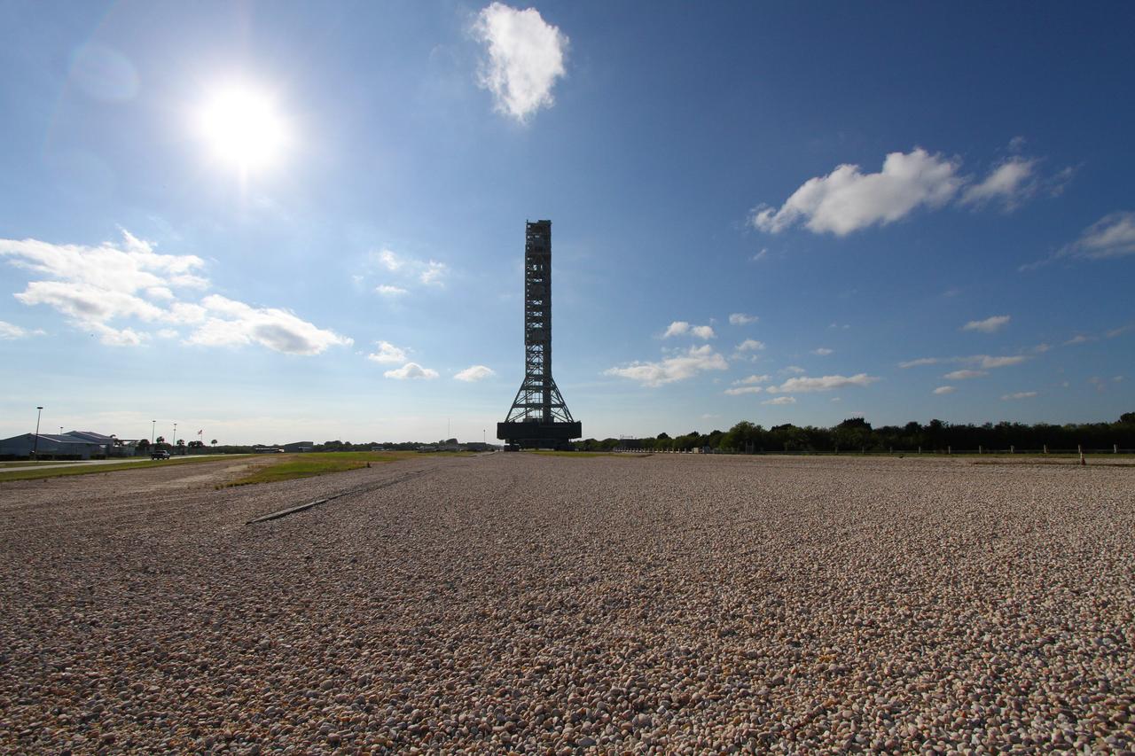 CAPE CANAVERAL, Fla. – The mobile launcher, or ML, towers above the crawlerway between Launch Pad 39B and the Vehicle Assembly Building at NASA's Kennedy Space Center in Florida.    Data on the ML collected from structural and functional engineering tests during its two-week stay on the pad will be used in the next phases of construction. The 355-foot-tall ML structure, which took about two years to construct, will be modified by NASA’s 21st Century Ground Systems Program to support NASA’s Space Launch System, the heavy-lift rocket that will launch astronauts into deep space on future exploration missions. For more information, visit http://www.nasa.gov/exploration/systems/sls. Photo credit: NASA/Cory Huston