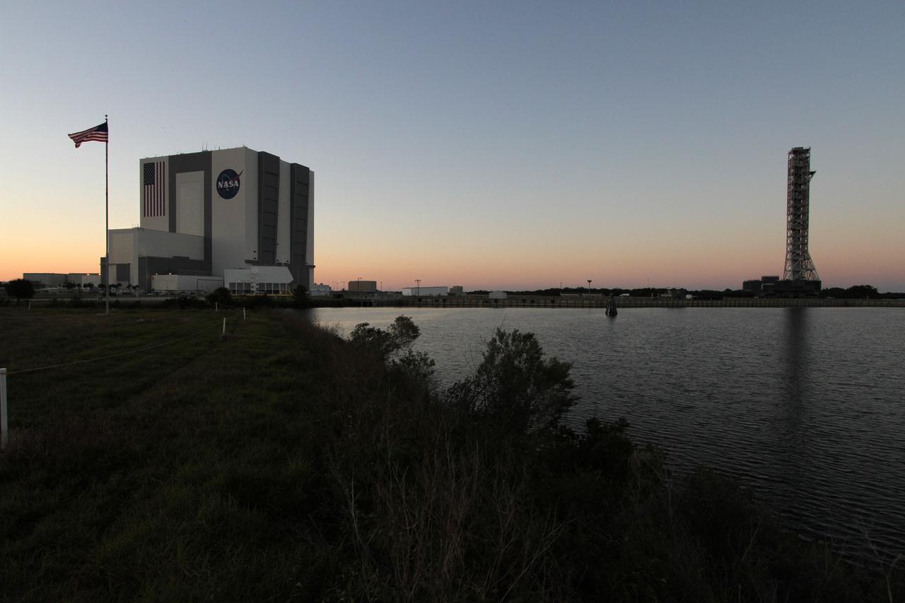 CAPE CANAVERAL, Fla. – The mobile launcher, or ML, makes its way past the turn basin as night descends on NASA's Kennedy Space Center in Florida. The ML is nearing the end of its 4.2-mile trek from Launch Pad 39B to the park site near the Vehicle Assembly Building.    Data on the ML collected from structural and functional engineering tests during its two-week stay on the pad will be used in the next phases of construction. The 355-foot-tall ML structure, which took about two years to construct, will be modified by NASA’s 21st Century Ground Systems Program to support NASA’s Space Launch System, the heavy-lift rocket that will launch astronauts into deep space on future exploration missions. For more information, visit http://www.nasa.gov/exploration/systems/sls. Photo credit: NASA/Cory Huston