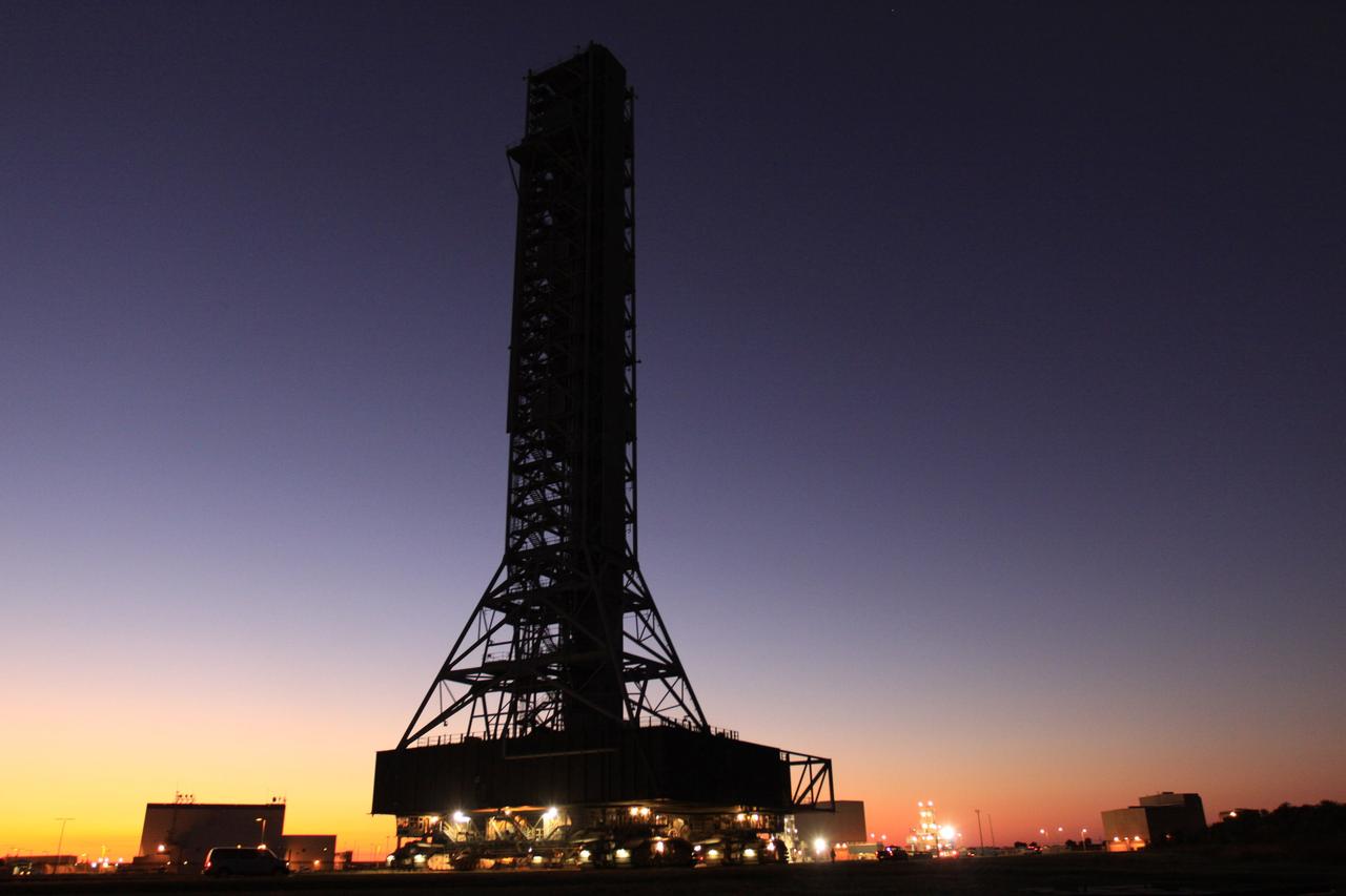 CAPE CANAVERAL, Fla. – Lights appear in the crawler-transporter under the mobile launcher, or ML, as its 4.2-mile, day-long trek from Launch Pad 39B to the park site near the Vehicle Assembly Building at NASA's Kennedy Space Center in Florida ends in darkness.     Data on the ML collected from structural and functional engineering tests during its two-week stay on the pad will be used in the next phases of construction. The 355-foot-tall ML structure, which took about two years to construct, will be modified by NASA’s 21st Century Ground Systems Program to support NASA’s Space Launch System, the heavy-lift rocket that will launch astronauts into deep space on future exploration missions. For more information, visit http://www.nasa.gov/exploration/systems/sls. Photo credit: NASA/Kim Shiflett