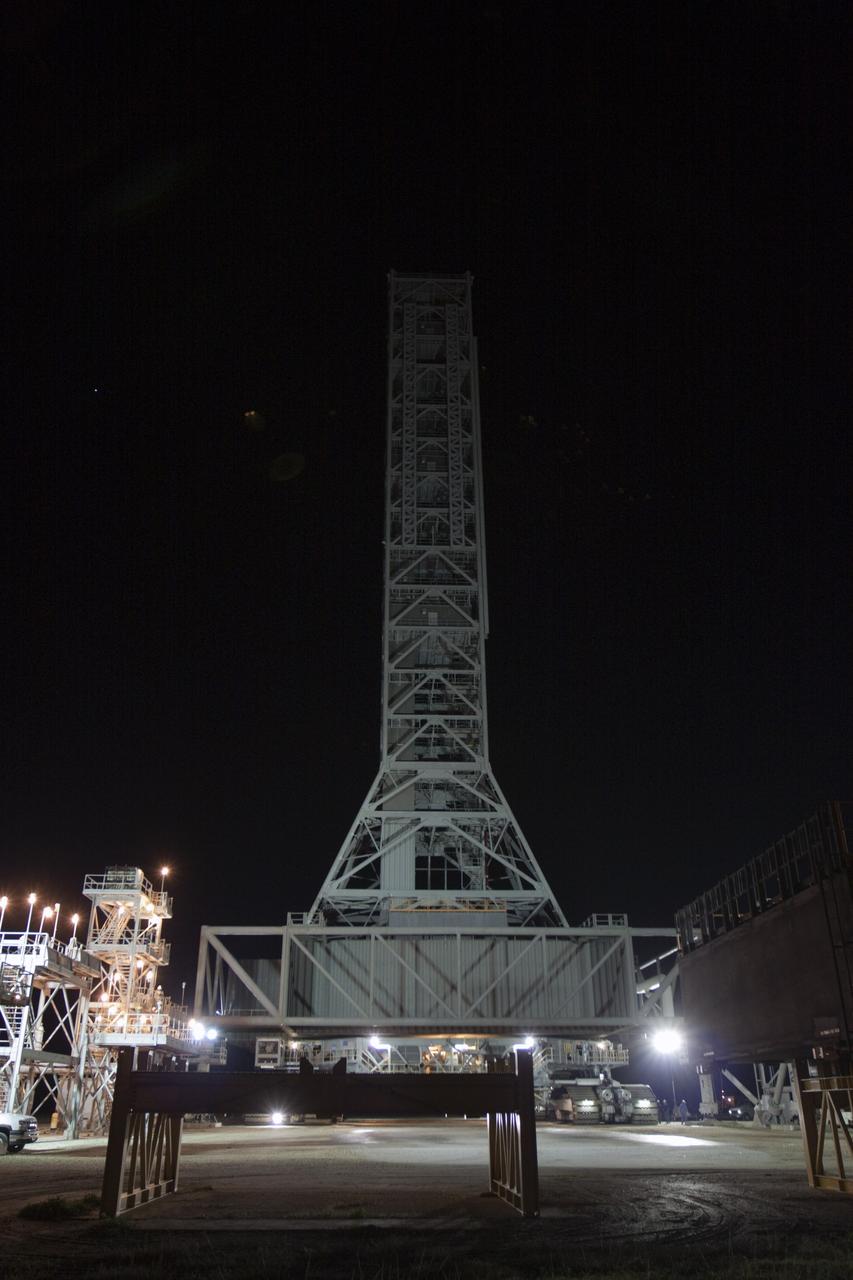 CAPE CANAVERAL, Fla. – The mobile launcher, or ML, arrives at the park site outside the Vehicle Assembly Building at NASA's Kennedy Space Center in Florida. The ML completed its 4.2-mile, day-long trek from Launch Pad 39B in darkness.    Data on the ML collected from structural and functional engineering tests during its two-week stay on the pad will be used in the next phases of construction. The 355-foot-tall ML structure, which took about two years to construct, will be modified by NASA’s 21st Century Ground Systems Program to support NASA’s Space Launch System, the heavy-lift rocket that will launch astronauts into deep space on future exploration missions. For more information, visit http://www.nasa.gov/exploration/systems/sls. Photo credit: NASA/Kim Shiflett