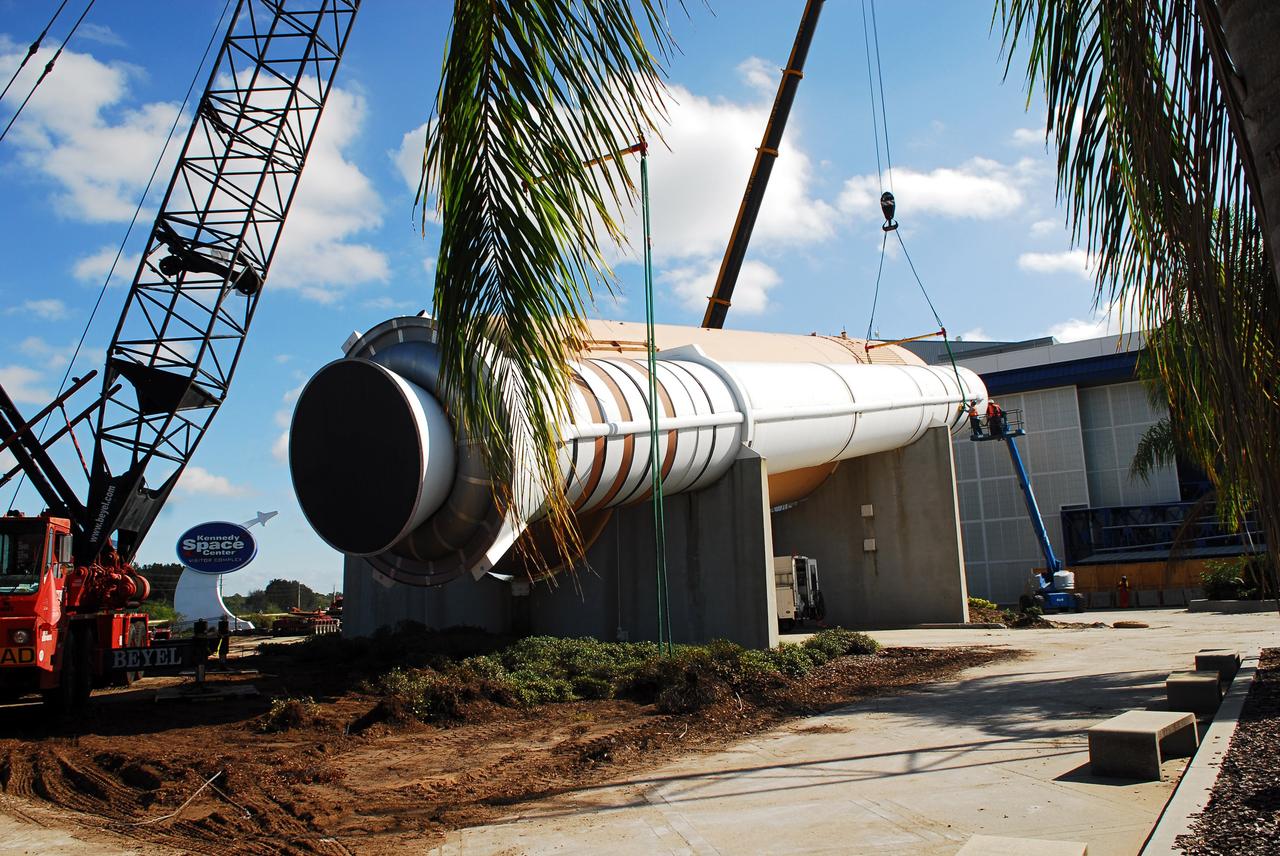 CAPE CANAVERAL, Fla. – Cranes remove a full-size, 149-foot-long, space shuttle solid rocket booster, or SRB, replica from the Kennedy Space Center Visitor Complex as the space-themed attraction makes way for a new exhibit featuring space shuttle Atlantis, which is currently undergoing preparations to go on public display. The SRB is being placed into temporary storage at NASA's Kennedy Space Center. The SRB was part of a mockup of the external tank and two SRBs at the visitor complex that were used to show visitors the size of actual space shuttle components. A space shuttle rode piggyback on the tank and boosters at liftoff and during the ascent into space. The SRBs burned out after about two-and-a-half minutes of flight. After recovery from the ocean, the boosters could be used repeatedly. Photo credit: NASA/Jim Grossman