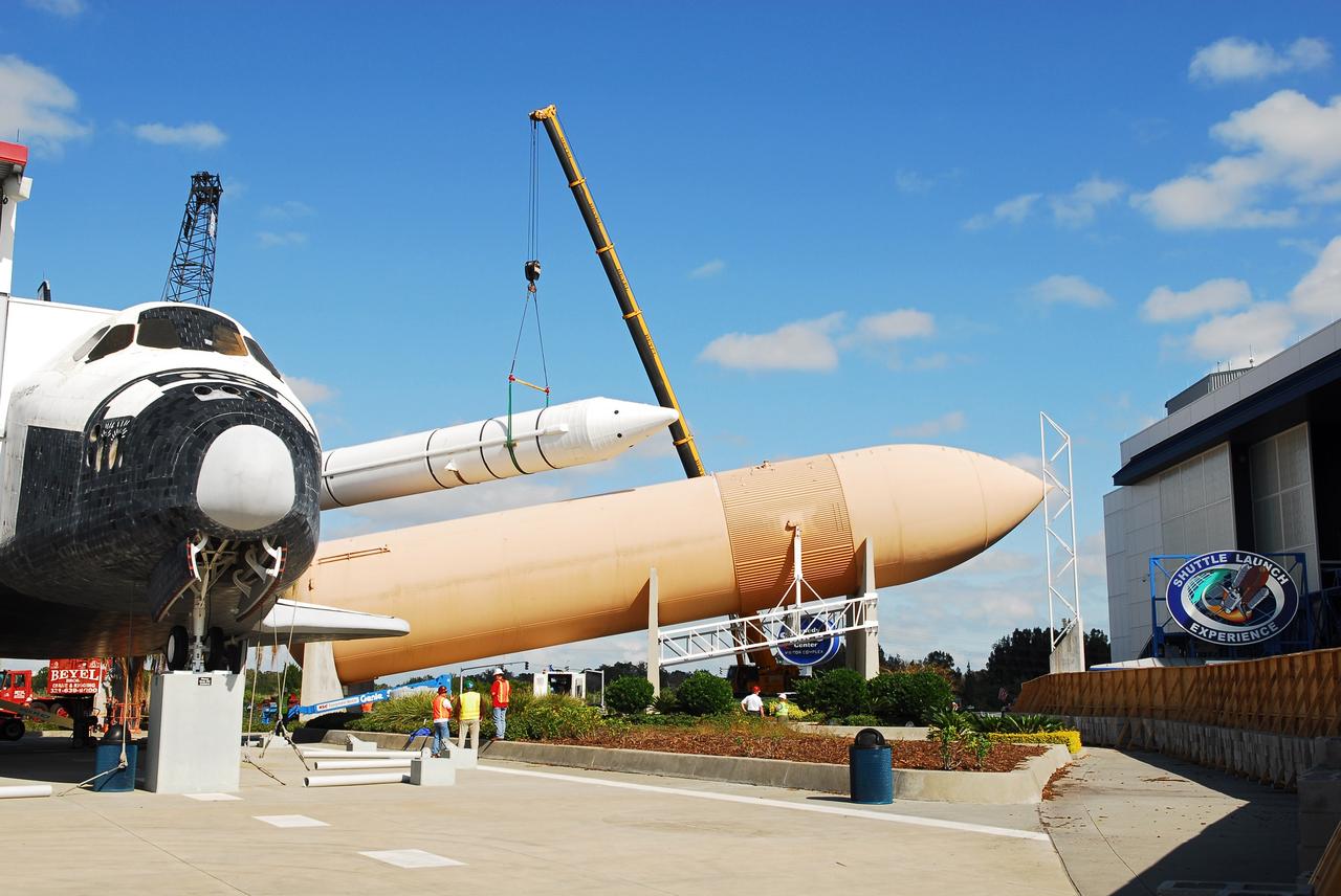 CAPE CANAVERAL, Fla. – Cranes remove a full-size, 149-foot-long, space shuttle solid rocket booster, or SRB, replica from the Kennedy Space Center Visitor Complex as the space-themed attraction makes way for a new exhibit featuring space shuttle Atlantis, which is currently undergoing preparations to go on public display. The SRB is being placed into temporary storage at NASA's Kennedy Space Center. The SRB was part of a mockup of the external tank and two SRBs at the visitor complex that were used to show visitors the size of actual space shuttle components. A space shuttle rode piggyback on the tank and boosters at liftoff and during the ascent into space. The SRBs burned out after about two-and-a-half minutes of flight. After recovery from the ocean, the boosters could be used repeatedly. Photo credit: NASA/Jim Grossman