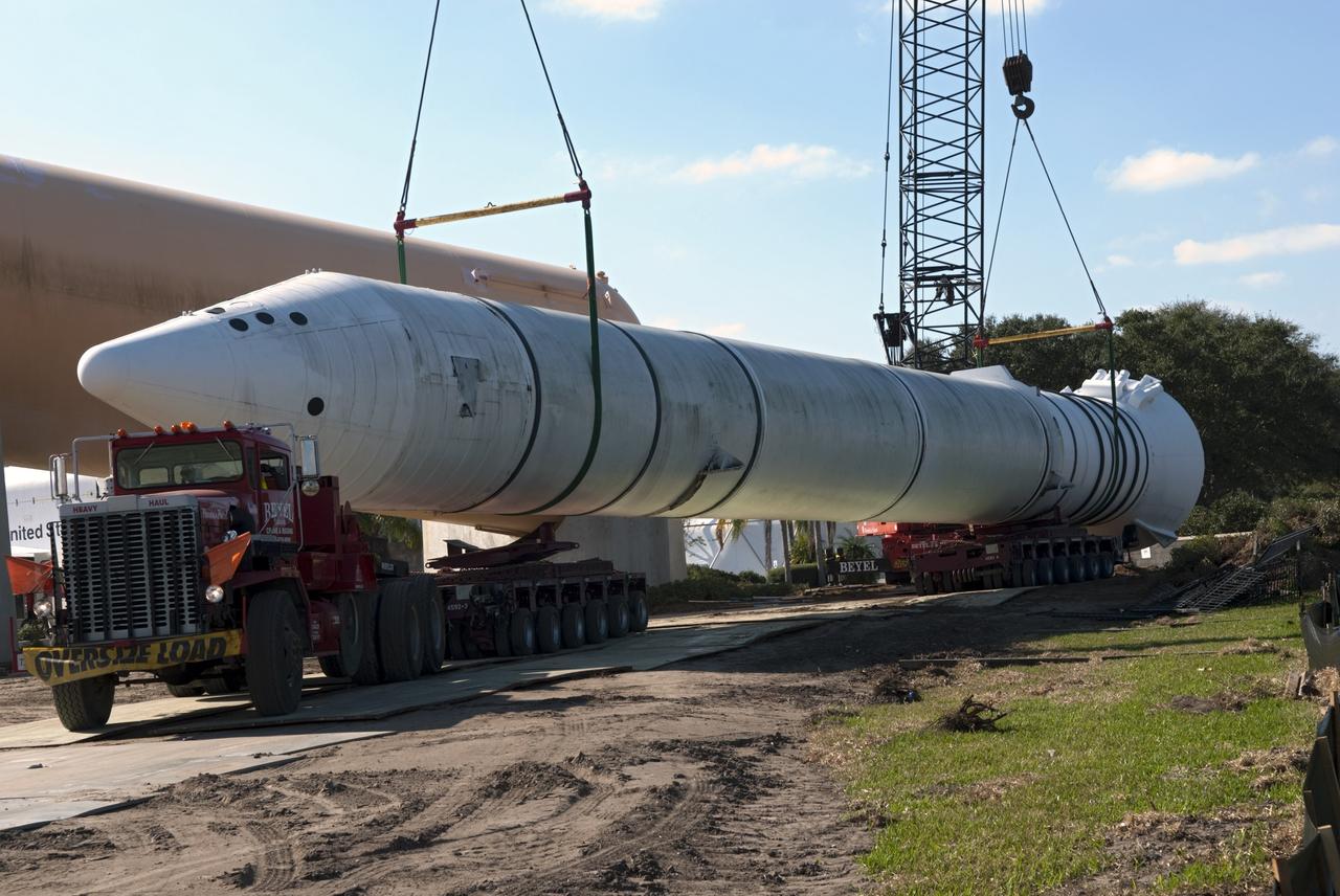 CAPE CANAVERAL, Fla. – Cranes remove a full-size, 149-foot-long, space shuttle solid rocket booster, or SRB, replica from the Kennedy Space Center Visitor Complex as the space-themed attraction makes way for a new exhibit featuring space shuttle Atlantis, which is currently undergoing preparations to go on public display. The SRB is being placed into temporary storage at NASA's Kennedy Space Center. The SRB was part of a mockup of the external tank and two SRBs at the visitor complex that were used to show visitors the size of actual space shuttle components. A space shuttle rode piggyback on the tank and boosters at liftoff and during the ascent into space. The SRBs burned out after about two-and-a-half minutes of flight. After recovery from the ocean, the boosters could be used repeatedly. Photo credit: NASA/Jim Grossman
