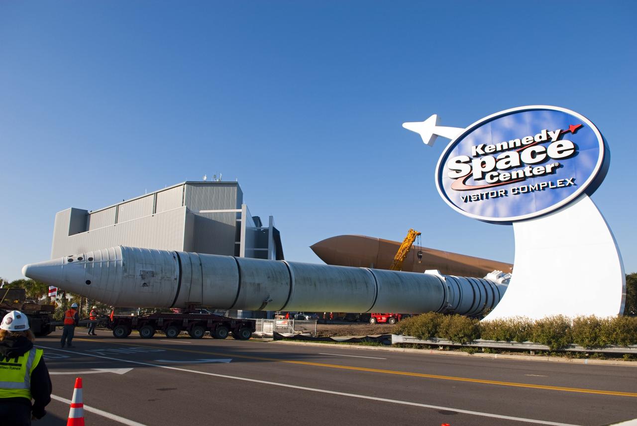 CAPE CANAVERAL, Fla. – A truck hauls a full-size, 149-foot-long, space shuttle solid rocket booster, or SRB, replica from the Kennedy Space Center Visitor Complex as the space-themed attraction makes way for a new exhibit featuring space shuttle Atlantis, which is currently undergoing preparations to go on public display. The SRB is being placed into temporary storage at NASA's Kennedy Space Center. The SRB was part of a mockup of the external tank and two SRBs at the visitor complex that were used to show visitors the size of actual space shuttle components. A space shuttle rode piggyback on the tank and boosters at liftoff and during the ascent into space. The SRBs burned out after about two-and-a-half minutes of flight. After recovery from the ocean, the boosters could be used repeatedly. Photo credit: NASA/Jim Grossman