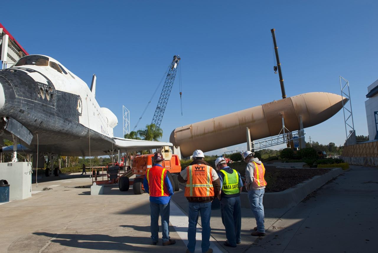 CAPE CANAVERAL, Fla. – Cranes remove a full-size replica of a space shuttle external fuel tank from the Kennedy Space Center Visitor Complex as the space-themed attraction makes way for a new exhibit featuring space shuttle Atlantis, which is currently undergoing preparations to go on public display. The tank is being placed into temporary storage at NASA's Kennedy Space Center. The tank was part of a mockup of the external tank and two solid rocket boosters at the visitor complex that were used to show visitors the size of actual space shuttle components. A space shuttle rode piggyback on the tank and boosters at liftoff and during the ascent into space. The tank, which held propellants for the shuttle's three main engines, was not reused, but burned up in the atmosphere and fell into the ocean. Photo credit: NASA/Jim Grossman