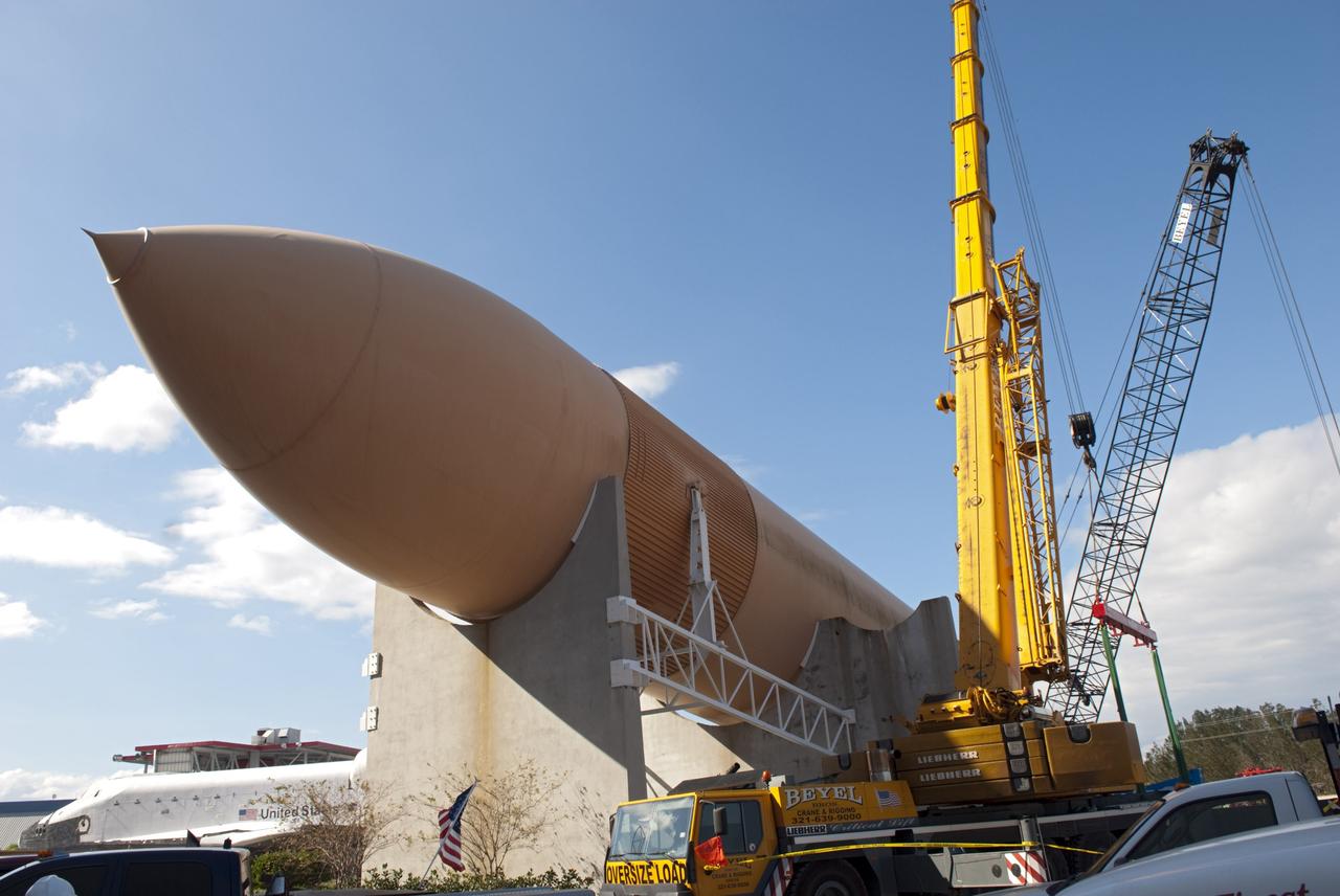 CAPE CANAVERAL, Fla. – Cranes remove a full-size replica of a space shuttle external fuel tank from the Kennedy Space Center Visitor Complex as the space-themed attraction makes way for a new exhibit featuring space shuttle Atlantis, which is currently undergoing preparations to go on public display. The tank is being placed into temporary storage at NASA's Kennedy Space Center. The tank was part of a mockup of the external tank and two solid rocket boosters at the visitor complex that were used to show visitors the size of actual space shuttle components. A space shuttle rode piggyback on the tank and boosters at liftoff and during the ascent into space. The tank, which held propellants for the shuttle's three main engines, was not reused, but burned up in the atmosphere and fell into the ocean. Photo credit: NASA/Jim Grossman