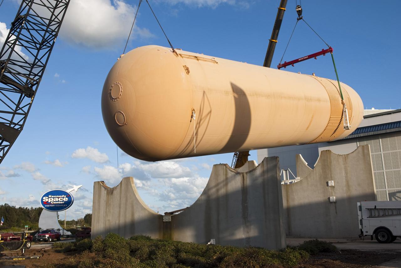 CAPE CANAVERAL, Fla. – Cranes remove a full-size replica of a space shuttle external fuel tank from the Kennedy Space Center Visitor Complex as the space-themed attraction makes way for a new exhibit featuring space shuttle Atlantis, which is currently undergoing preparations to go on public display. The tank is being placed into temporary storage at NASA's Kennedy Space Center. The tank was part of a mockup of the external tank and two solid rocket boosters at the visitor complex that were used to show visitors the size of actual space shuttle components. A space shuttle rode piggyback on the tank and boosters at liftoff and during the ascent into space. The tank, which held propellants for the shuttle's three main engines, was not reused, but burned up in the atmosphere and fell into the ocean. Photo credit: NASA/Jim Grossman