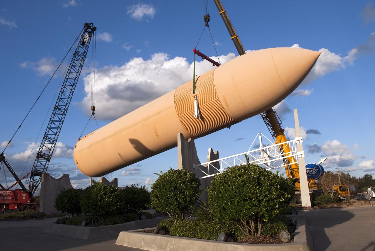 CAPE CANAVERAL, Fla. – Cranes remove a full-size replica of a space shuttle external fuel tank from the Kennedy Space Center Visitor Complex as the space-themed attraction makes way for a new exhibit featuring space shuttle Atlantis, which is currently undergoing preparations to go on public display. The tank is being placed into temporary storage at NASA's Kennedy Space Center. The tank was part of a mockup of the external tank and two solid rocket boosters at the visitor complex that were used to show visitors the size of actual space shuttle components. A space shuttle rode piggyback on the tank and boosters at liftoff and during the ascent into space. The tank, which held propellants for the shuttle's three main engines, was not reused, but burned up in the atmosphere and fell into the ocean. Photo credit: NASA/Jim Grossman