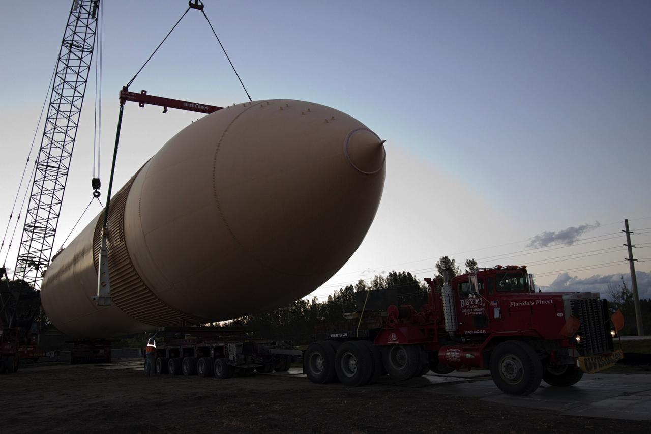 CAPE CANAVERAL, Fla. – Cranes remove a full-size replica of a space shuttle external fuel tank from the Kennedy Space Center Visitor Complex as the space-themed attraction makes way for a new exhibit featuring space shuttle Atlantis, which is currently undergoing preparations to go on public display. The tank is being placed into temporary storage at NASA's Kennedy Space Center. The tank was part of a mockup of the external tank and two solid rocket boosters at the visitor complex that were used to show visitors the size of actual space shuttle components. A space shuttle rode piggyback on the tank and boosters at liftoff and during the ascent into space. The tank, which held propellants for the shuttle's three main engines, was not reused, but burned up in the atmosphere and fell into the ocean. Photo credit: NASA/Jim Grossman