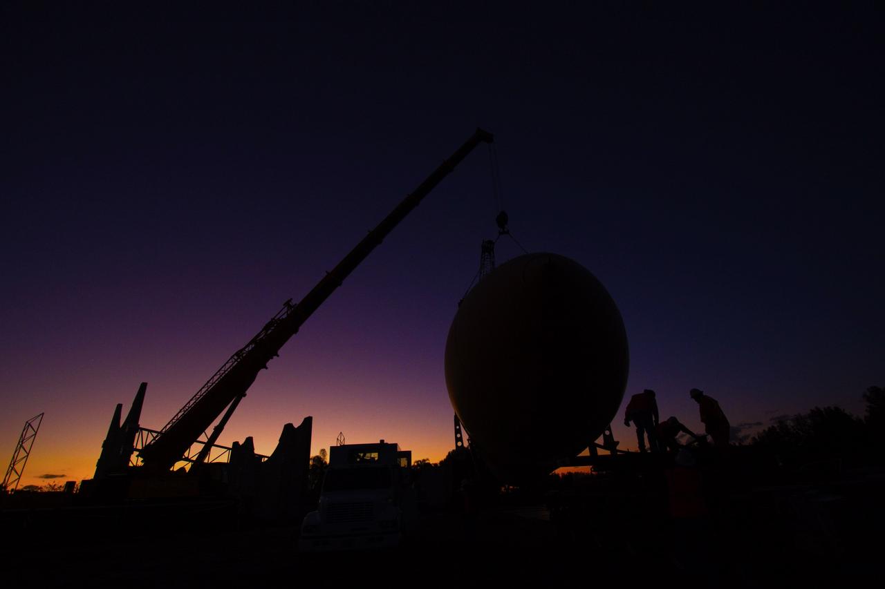 CAPE CANAVERAL, Fla. – Cranes remove a full-size replica of a space shuttle external fuel tank from the Kennedy Space Center Visitor Complex as the space-themed attraction makes way for a new exhibit featuring space shuttle Atlantis, which is currently undergoing preparations to go on public display. The tank is being placed into temporary storage at NASA's Kennedy Space Center. The tank was part of a mockup of the external tank and two solid rocket boosters at the visitor complex that were used to show visitors the size of actual space shuttle components. A space shuttle rode piggyback on the tank and boosters at liftoff and during the ascent into space. The tank, which held propellants for the shuttle's three main engines, was not reused, but burned up in the atmosphere and fell into the ocean. Photo credit: NASA/Jim Grossman