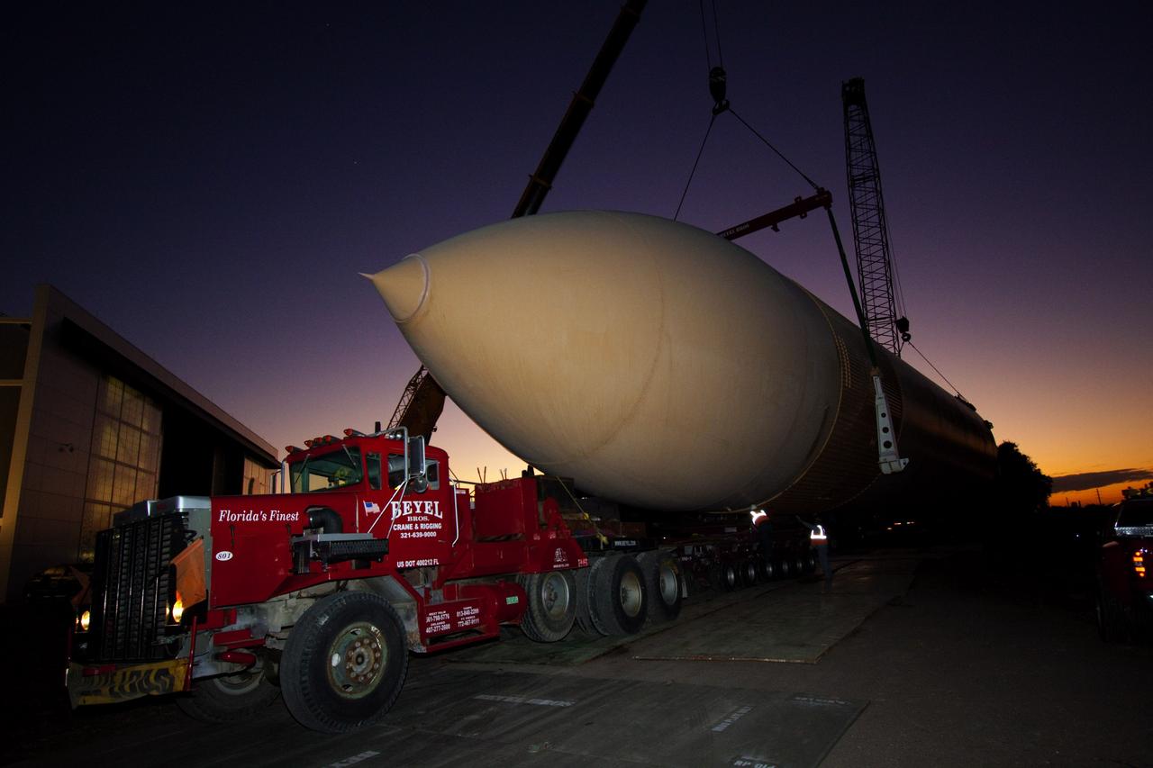 CAPE CANAVERAL, Fla. – Cranes remove a full-size replica of a space shuttle external fuel tank from the Kennedy Space Center Visitor Complex as the space-themed attraction makes way for a new exhibit featuring space shuttle Atlantis, which is currently undergoing preparations to go on public display. The tank is being placed into temporary storage at NASA's Kennedy Space Center. The tank was part of a mockup of the external tank and two solid rocket boosters at the visitor complex that were used to show visitors the size of actual space shuttle components. A space shuttle rode piggyback on the tank and boosters at liftoff and during the ascent into space. The tank, which held propellants for the shuttle's three main engines, was not reused, but burned up in the atmosphere and fell into the ocean. Photo credit: NASA/Jim Grossman