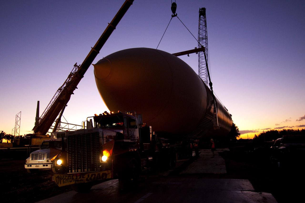 CAPE CANAVERAL, Fla. – Cranes remove a full-size replica of a space shuttle external fuel tank from the Kennedy Space Center Visitor Complex as the space-themed attraction makes way for a new exhibit featuring space shuttle Atlantis, which is currently undergoing preparations to go on public display. The tank is being placed into temporary storage at NASA's Kennedy Space Center. The tank was part of a mockup of the external tank and two solid rocket boosters at the visitor complex that were used to show visitors the size of actual space shuttle components. A space shuttle rode piggyback on the tank and boosters at liftoff and during the ascent into space. The tank, which held propellants for the shuttle's three main engines, was not reused, but burned up in the atmosphere and fell into the ocean. Photo credit: NASA/Jim Grossman